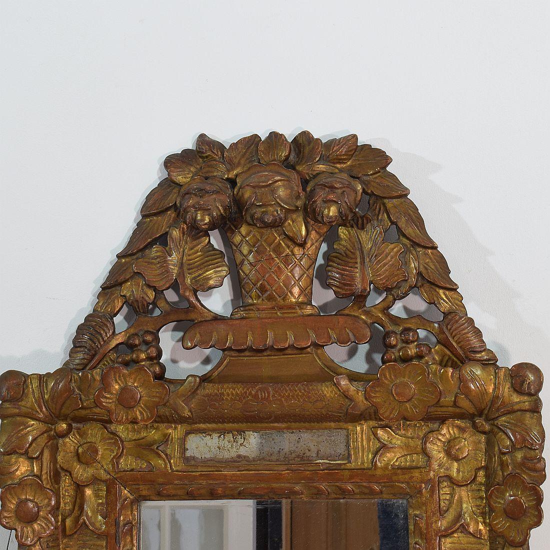 Stunning piece with original color, gilding and mirror glass, France, circa 1850. Weathered, small losses and old repairs at the small cracks in the crest.