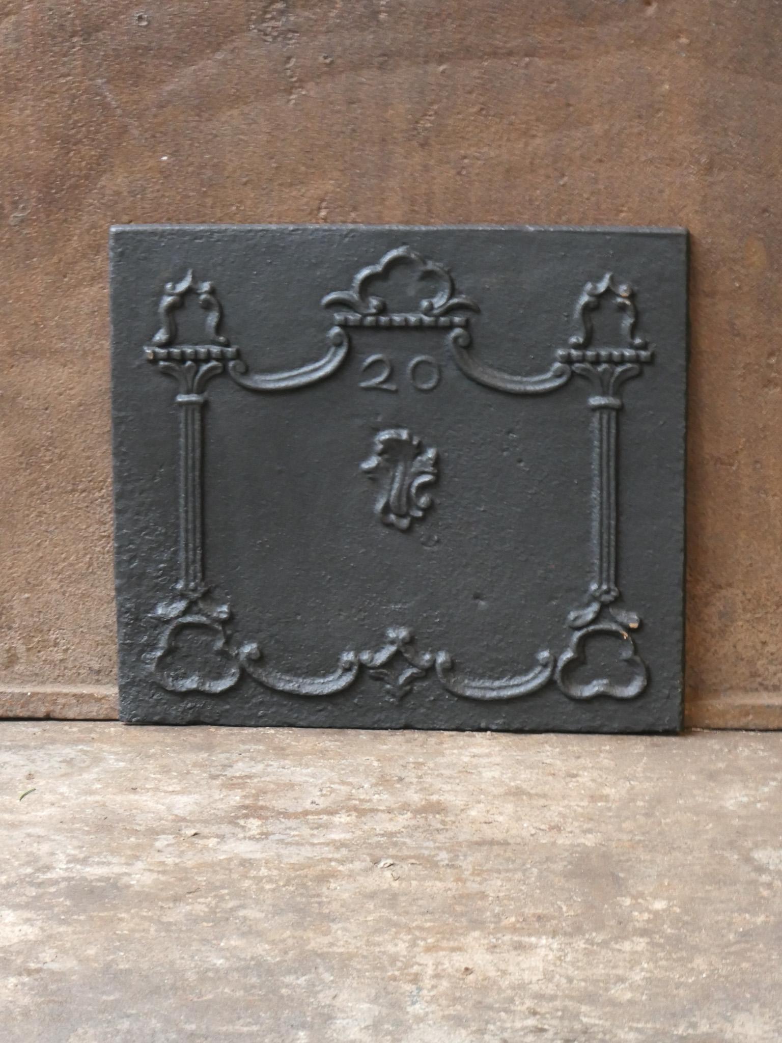 Small and elegant 18th century French Louis XV fireback.

The fireback is made of cast iron and has a black / pewter patina. The condition is good. It does not have cracks.