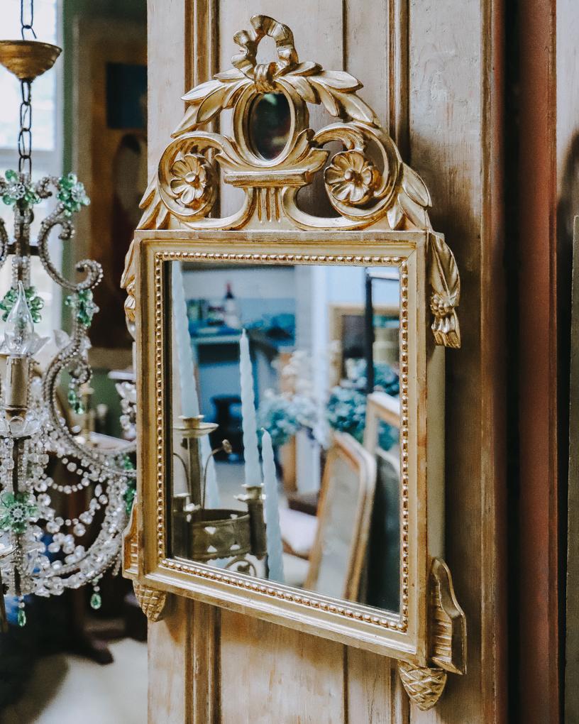 Very charming, French, Louis XVI style parcel gilt marriage trumeau mirror, with a cute small mirror as crest.

Other neoclassical ornaments include laurel leaves, tassels and pearl beading. Laurel has a very rich symbolic meaning in western