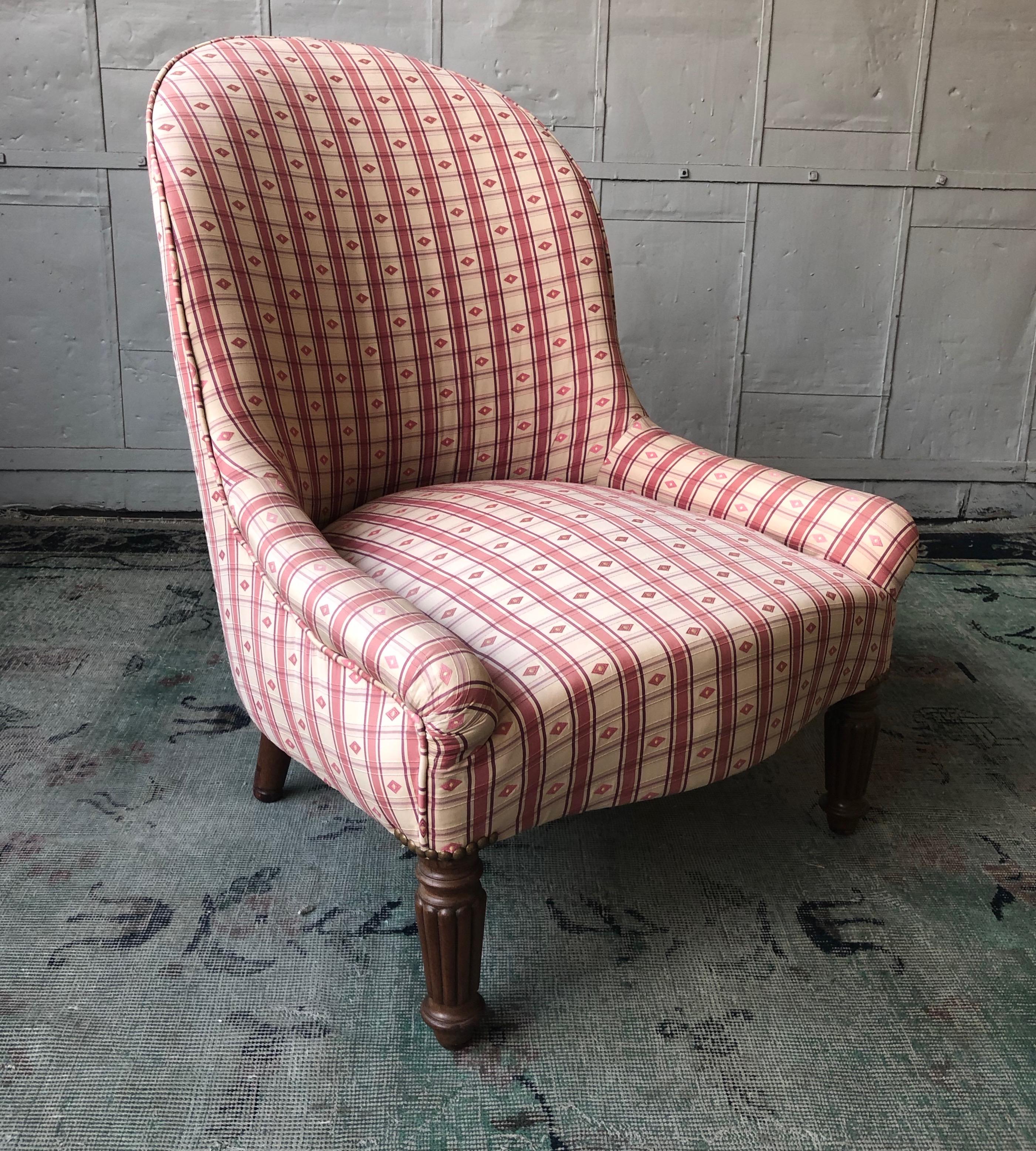 A charming small lady's slipper chair recently upholstered in a pattern fabric. The chair is in very good condition. Front casters can be added to increase the seat height to 13 inches. French, circa 1920.