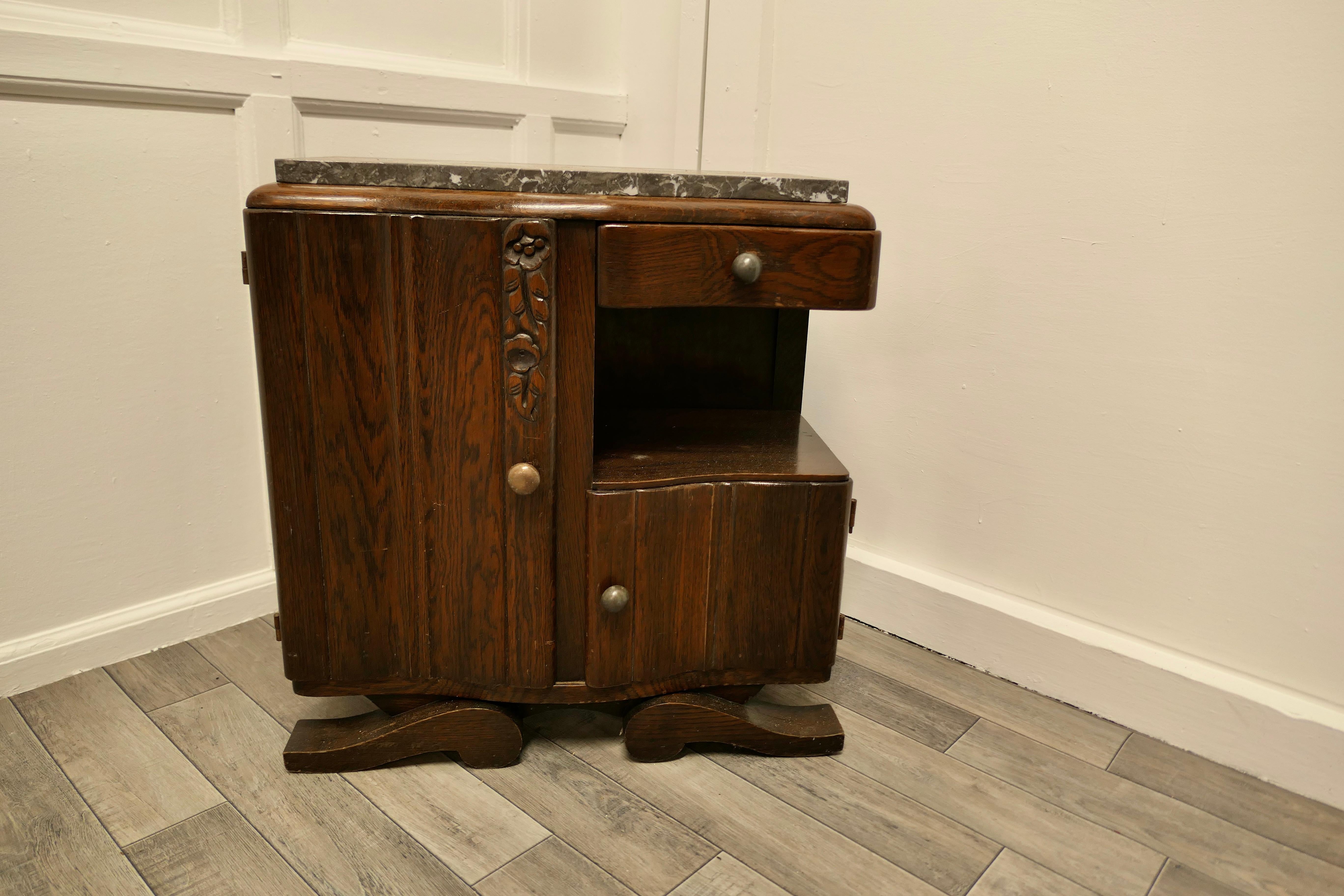 Small French Odeon Style Art Deco Marble Top Oak Cabinet 

This is a very stylish piece, the cabinet has 2 doors, a drawer and an open undertier, it is made in Oak with a Grey Marble top and it stands on inturned sleigh feet
Stylish and sturdy and