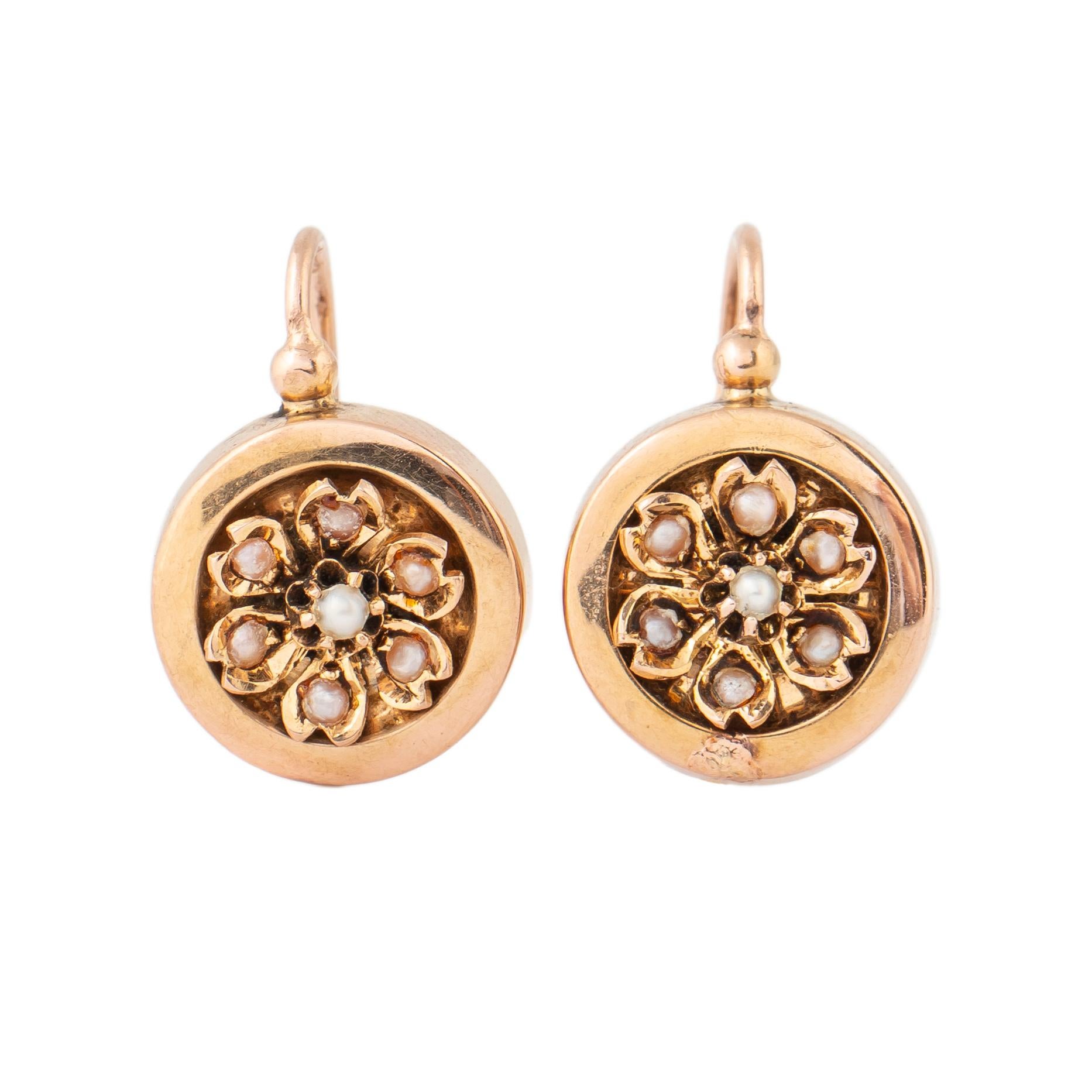 This beautiful pair of French 18k rose gold earrings from the 19th century enhanced with a cluster of seed pearl flowers and attached to gold wires for pierced ears. 

France, 19th century, hallmarked.

Earring 3/4 in. (1.9 cm); size of drop: 1/2