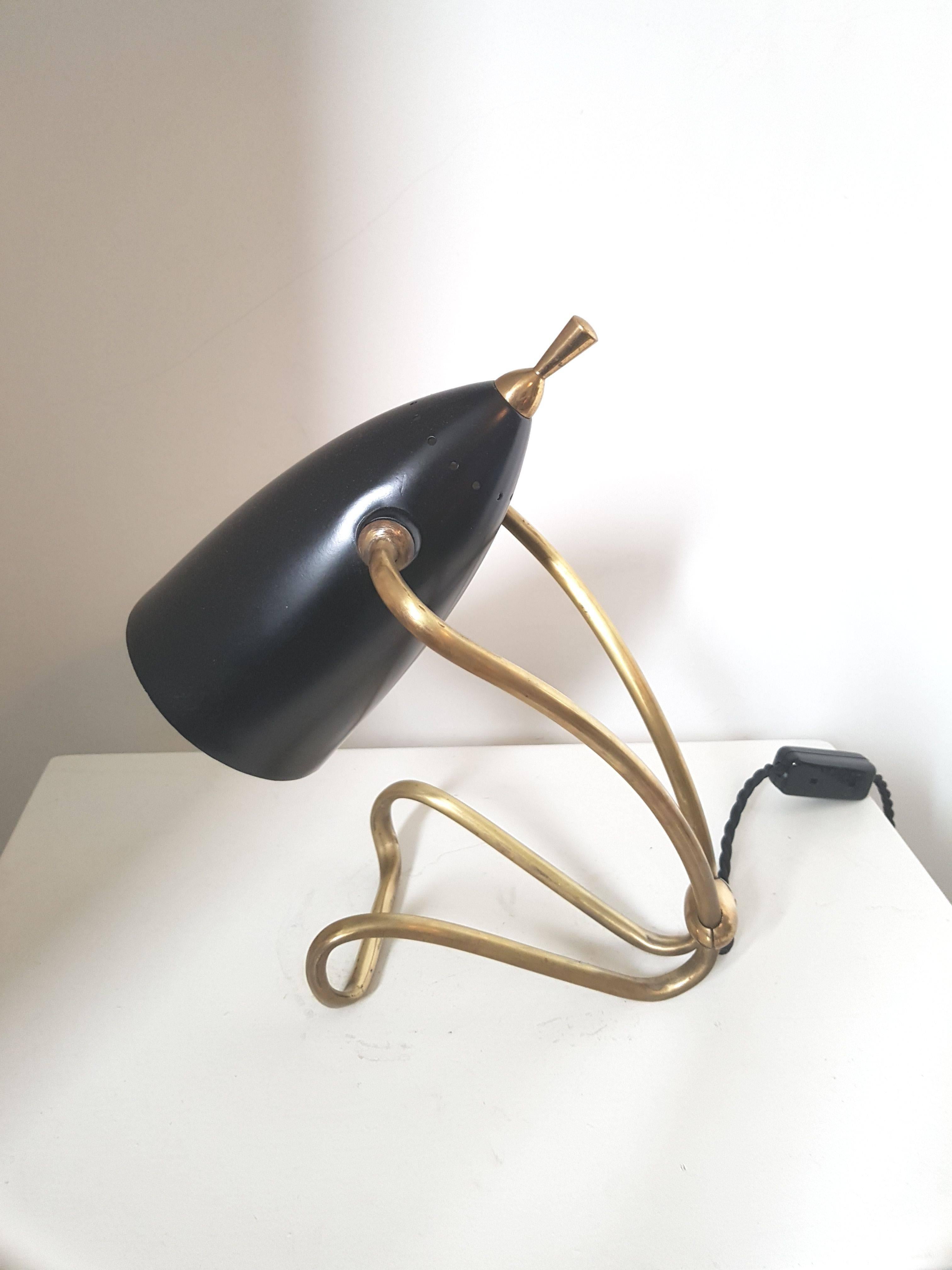 Small French table lamp in brass with articulated black lacquered shade.