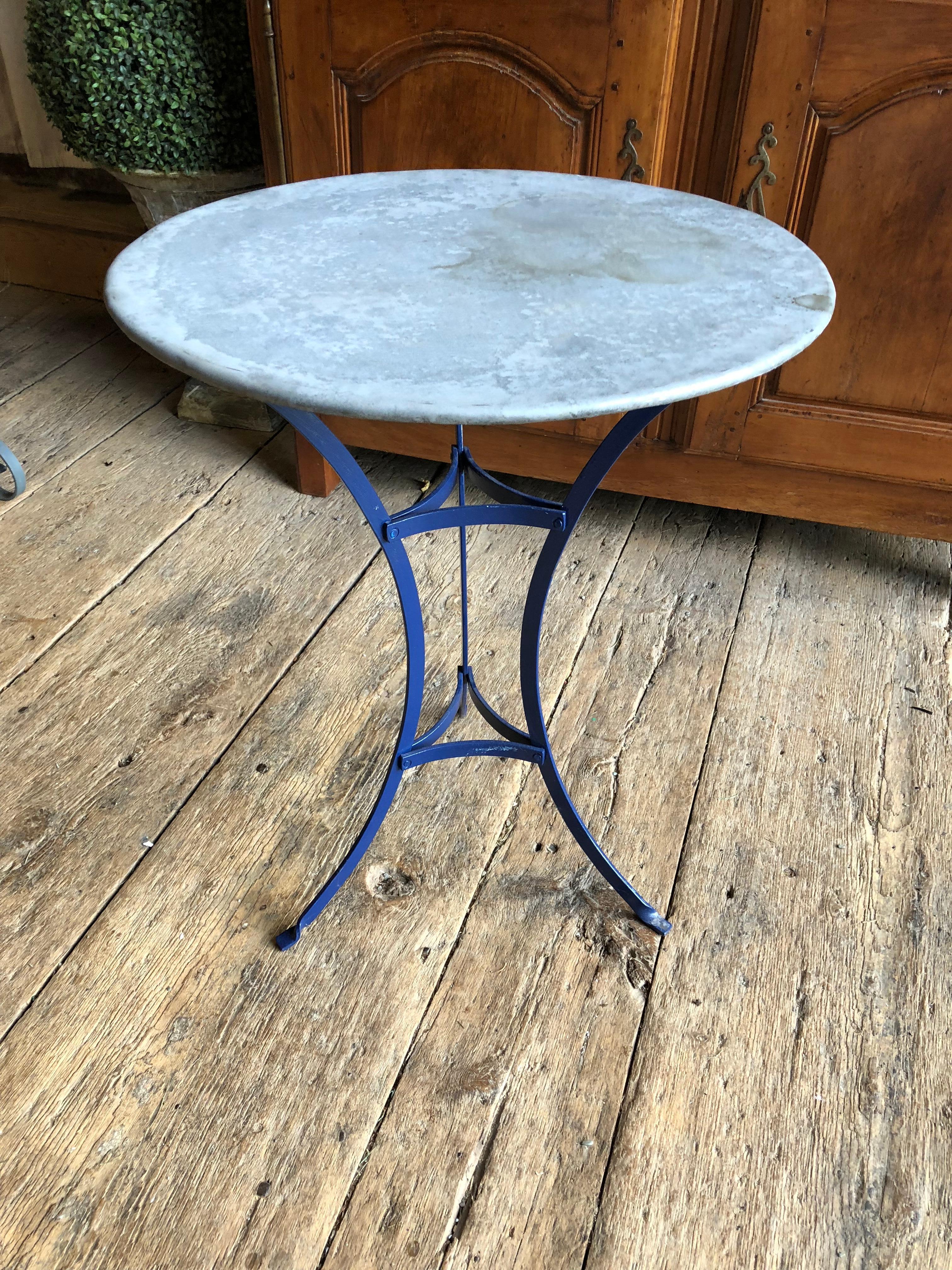 A small zinc-top bistro table with blue painted iron base, 20th century.