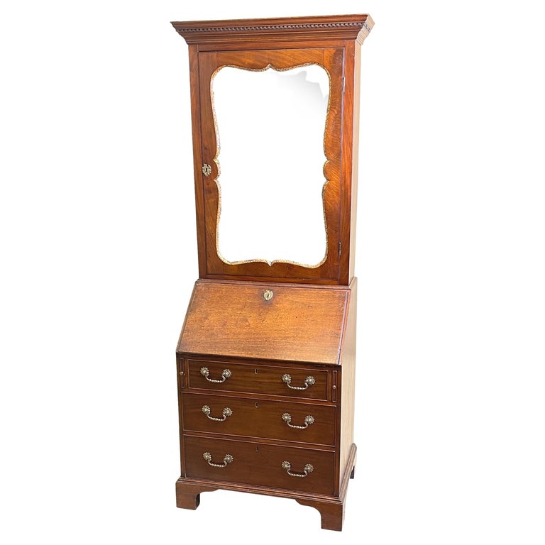A Very Attractive Mid 18th Century, Georgian Mahogany Bureau bookcase Of Very Attractive, Rare, Small Proportions, With Dental Cornice Above Shaped Mirror Door Within Gilded Slip, Over Well Figured Flap And Three Long Drawers With Original Brass