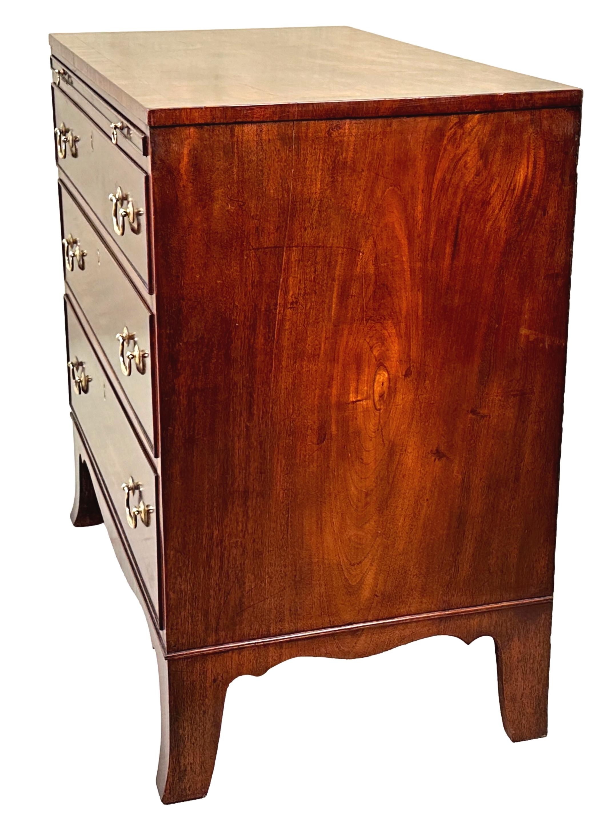 A Very Good Quality Early 19th Century, George III Period Mahogany Chest Of Unusual Small Proportions, Having Superbly Figured Rectanglar Top With Crossbanded Decoration, Over Slide And Three Long Drawers Retaining Original Brass Swan Neck Handles,