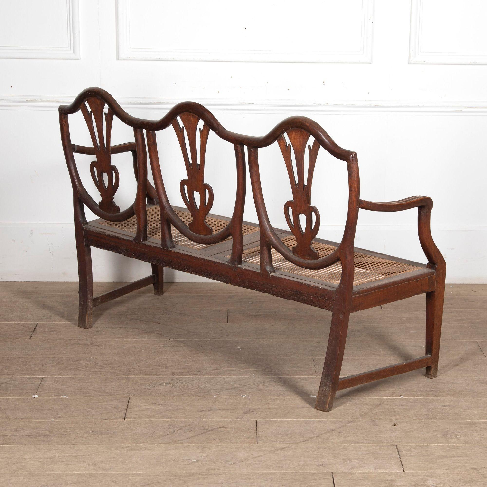 Small Georgian mahogany Hepplewhite settee.
Dating from the late 18th century, Circa 1780, this superb mahogany triple-shield back settee is of small proportions in the style of George Hepplewhite.
The carved shield backs with corn sprouting from