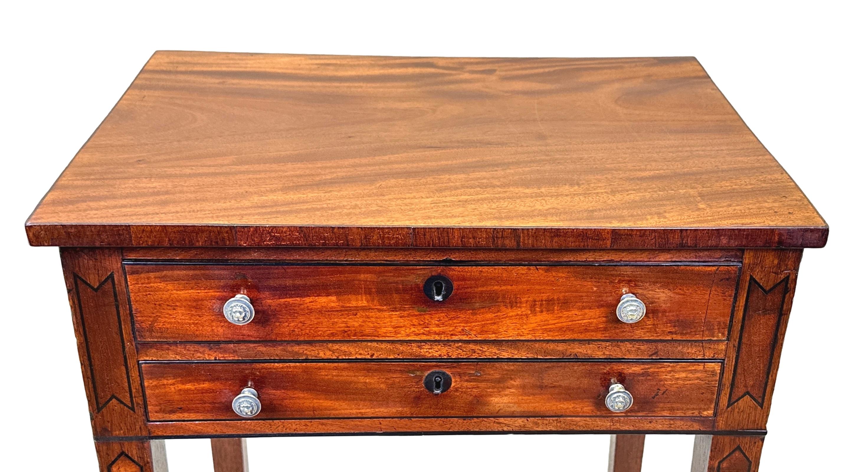 A Good Quality Late 18th Century, George III Period, Mahogany Rectangular Occasional Lamp Table, Having Well Figured Top Over Two Shallow Drawers With Replacement Brass Knobs And Attractive Ebonised Strung Decoration Throughout, Raised On Elegant