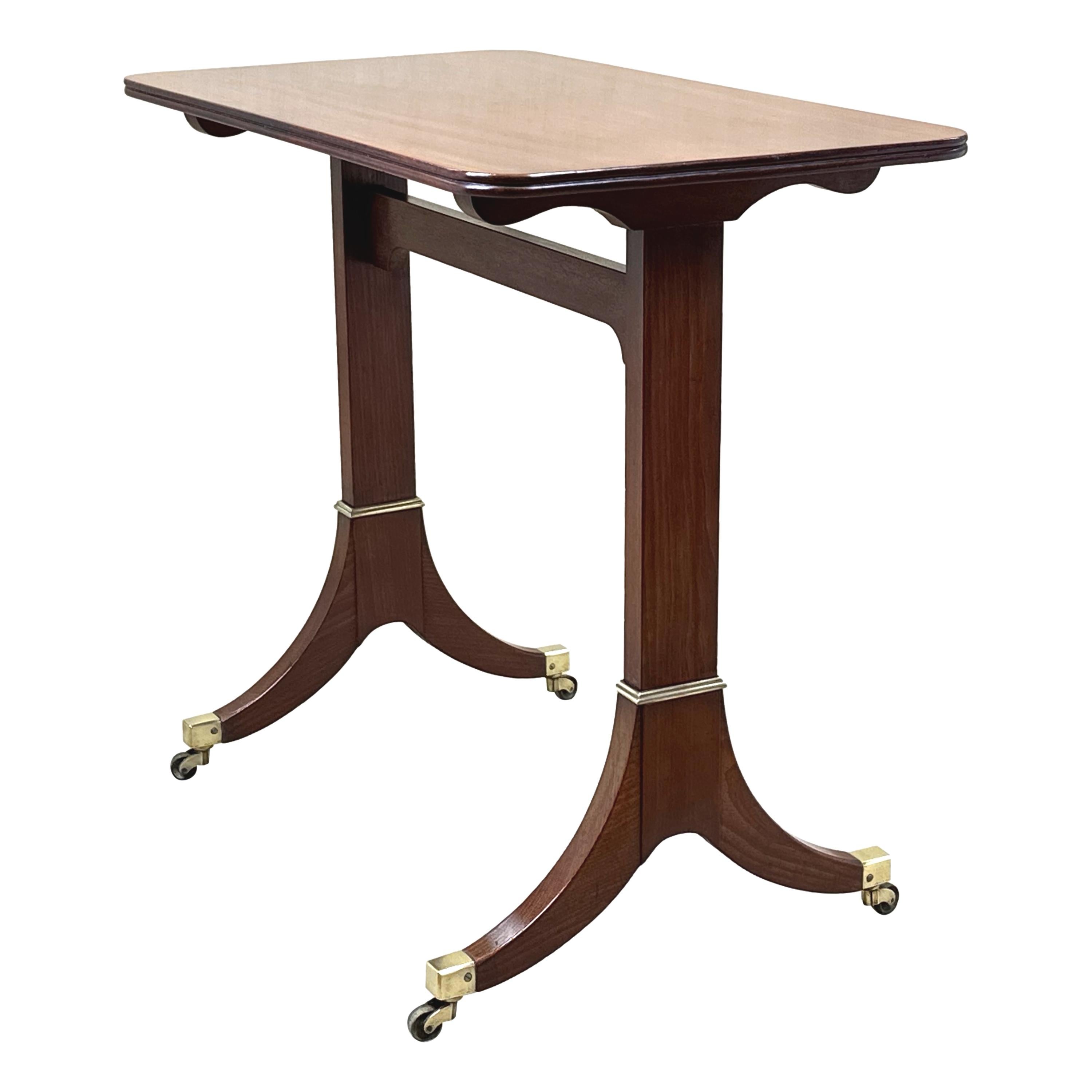 A Fine Quality Early 19th Century, George III Period, Mahogany Library Table Of Unusually Small Proportions, Having Well Figured Rectangular Top With Elegant Tablet End Supports, United By High Stretcher, With Attractive Brass Moulded Decoration And