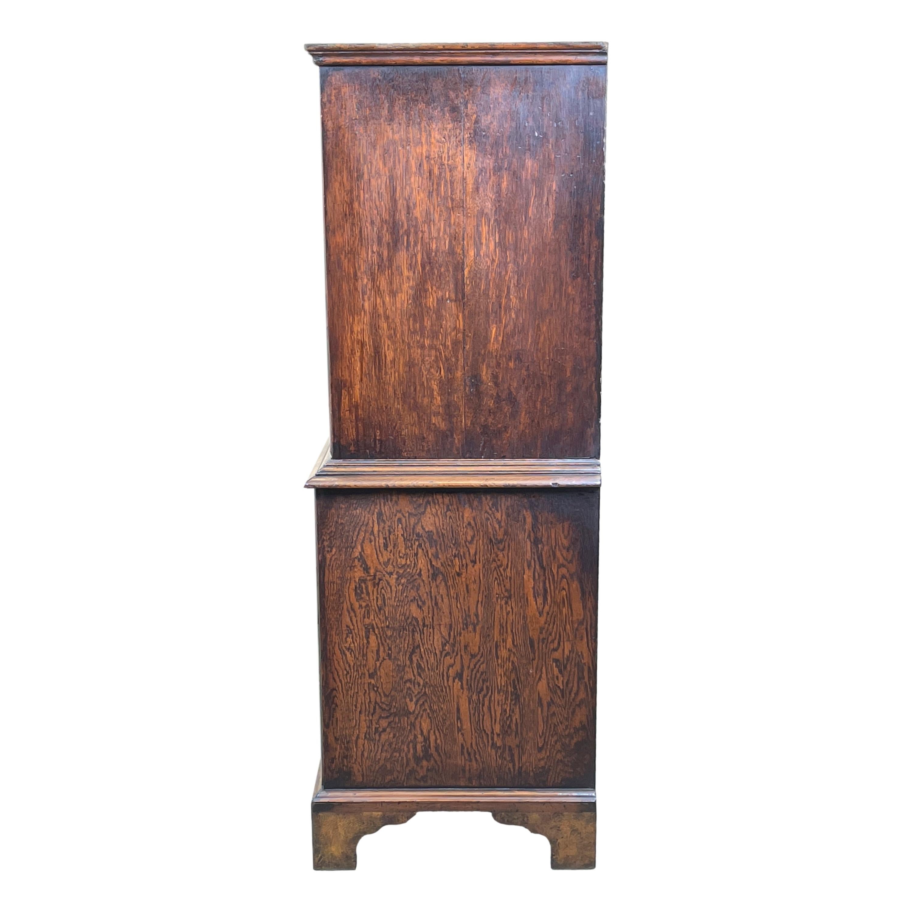 A charming early 18th century George I period walnut tallboy, or chest on chest, of extremely rare small proportions having quarter veneered & cross banded top over two short & six long superbly figured & cross banded drawers with replacement brass