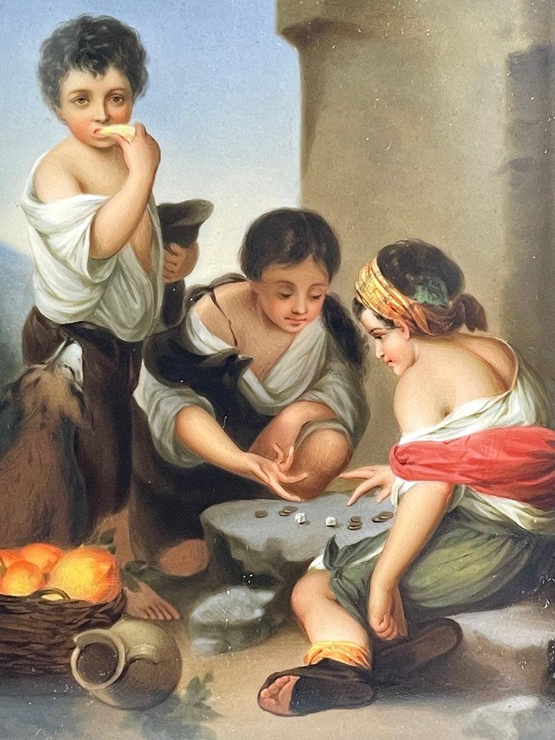 Small German porcelain plaque after a 17th C. painting of Murillo

Small German porcelain plaque after a 17th Century painting of Bartolome Esteban Murillo (1618-1682) with a scene of children playing with dice, 1670
Framed in carved oak wood
On