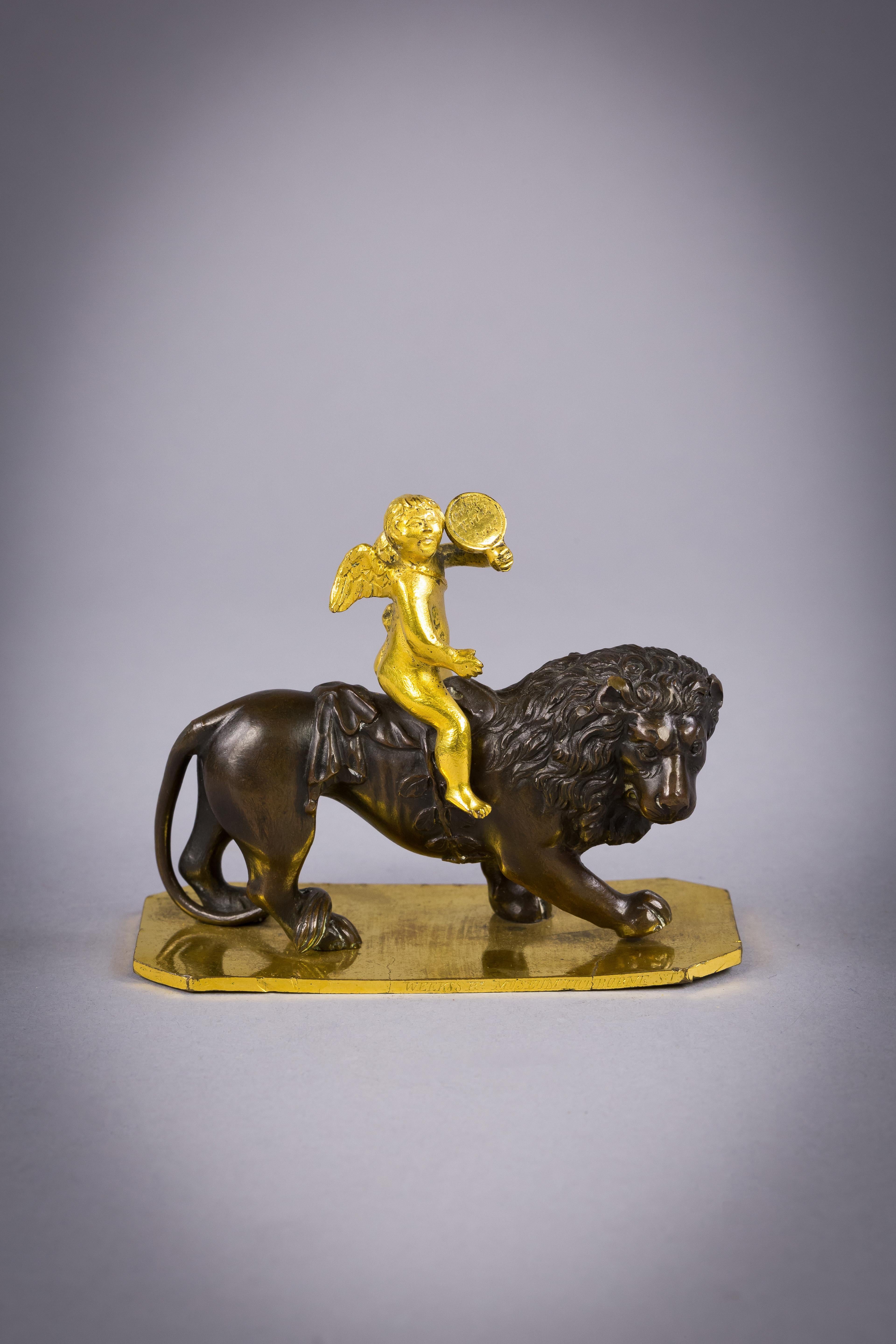 French Small Gilt and Patinated Bronze of Cupid on a Lion, circa 1820 For Sale
