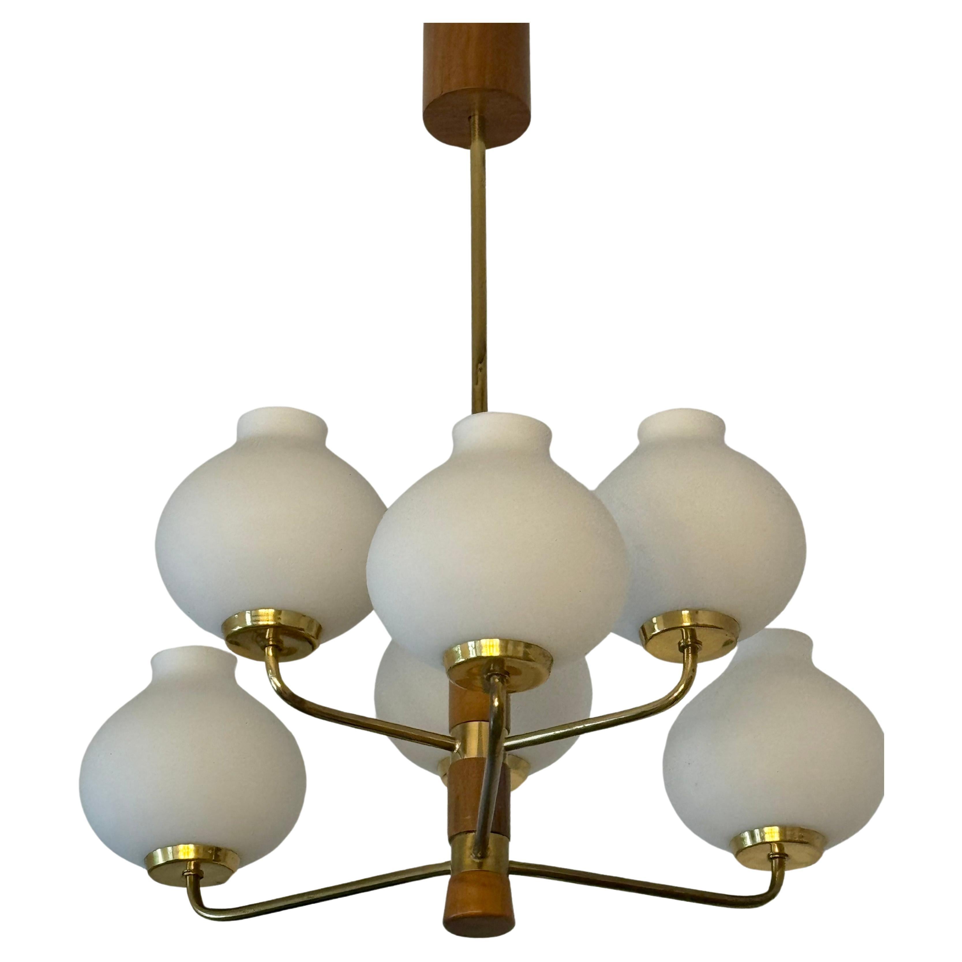 A small Mid-Century Modern milk glass, gilt brass and wood chandelier by Temde, Switzerland, circa 1950s.
Socket: 6 x E 14 for standard screw bulbs.
 In a very good vintage condition.