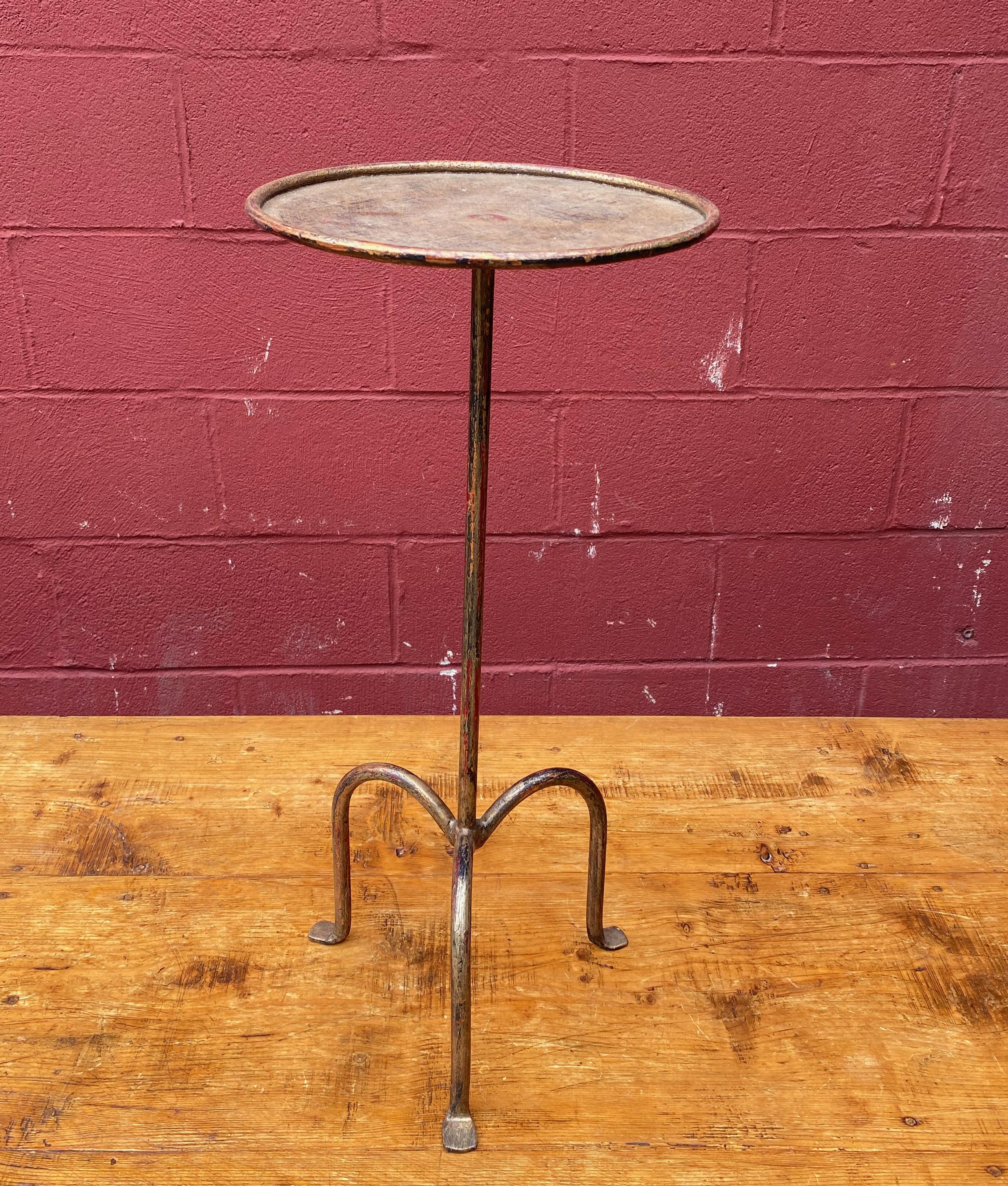 Small gilt iron and metal end table, perfect for a drink and can easily be moved around as needed. The original finish shows several under layers of black and red, making for a rich patina. Spanish, 1950s.

Ref #: TG0321-03

Dimensions: 26.5