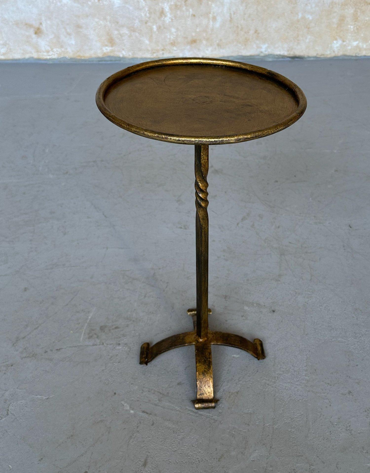 This handsome Spanish drinks table, recently crafted by European artisans, embodies timeless elegance. Featuring a twisted central stem, scrolled-foot base, and rolled-edge round top, it combines aesthetic appeal with practical functionality. The