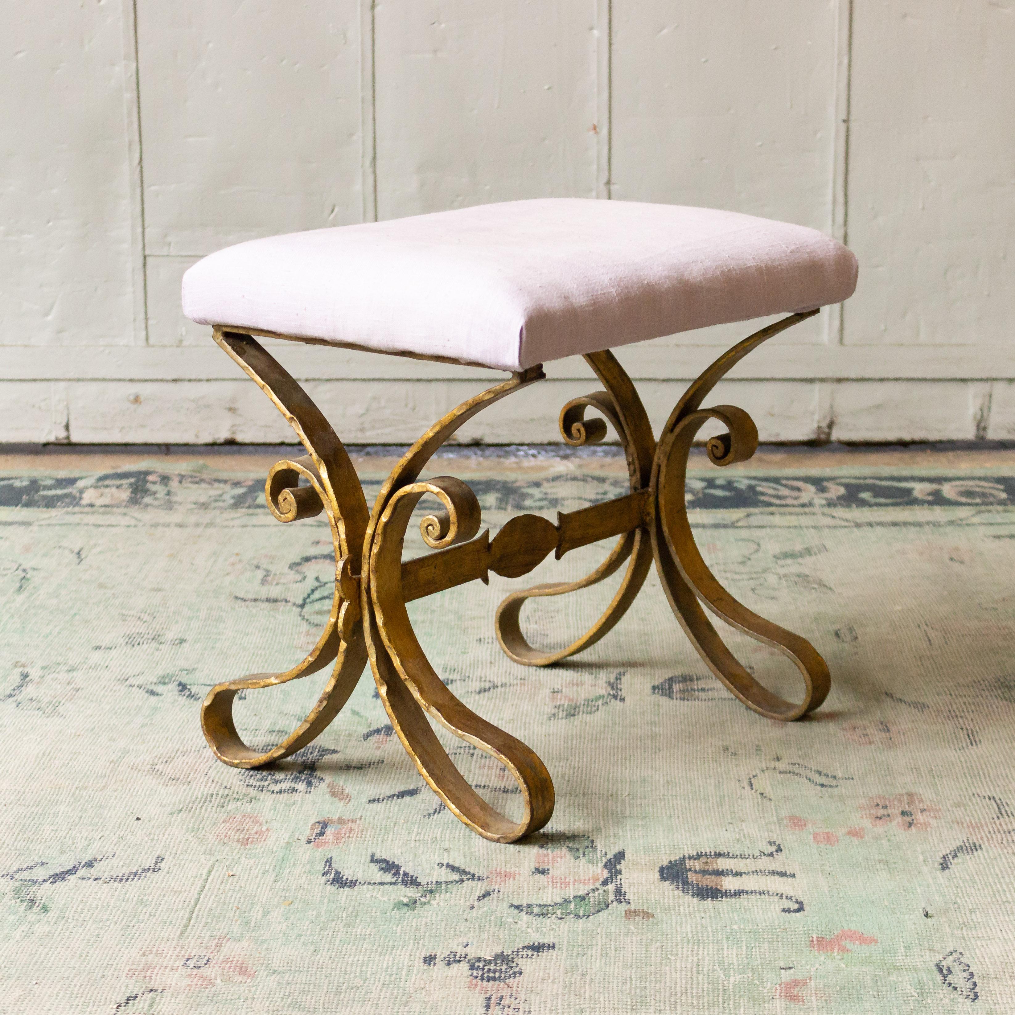 A unique Spanish gilt iron bench with an ornate base. Add a vintage touch to your space with this exquisite small gilt iron bench from Spain. Dating back to the 1950s, the ornate base adds an extra level of detail that makes it truly one-of-a-kind.