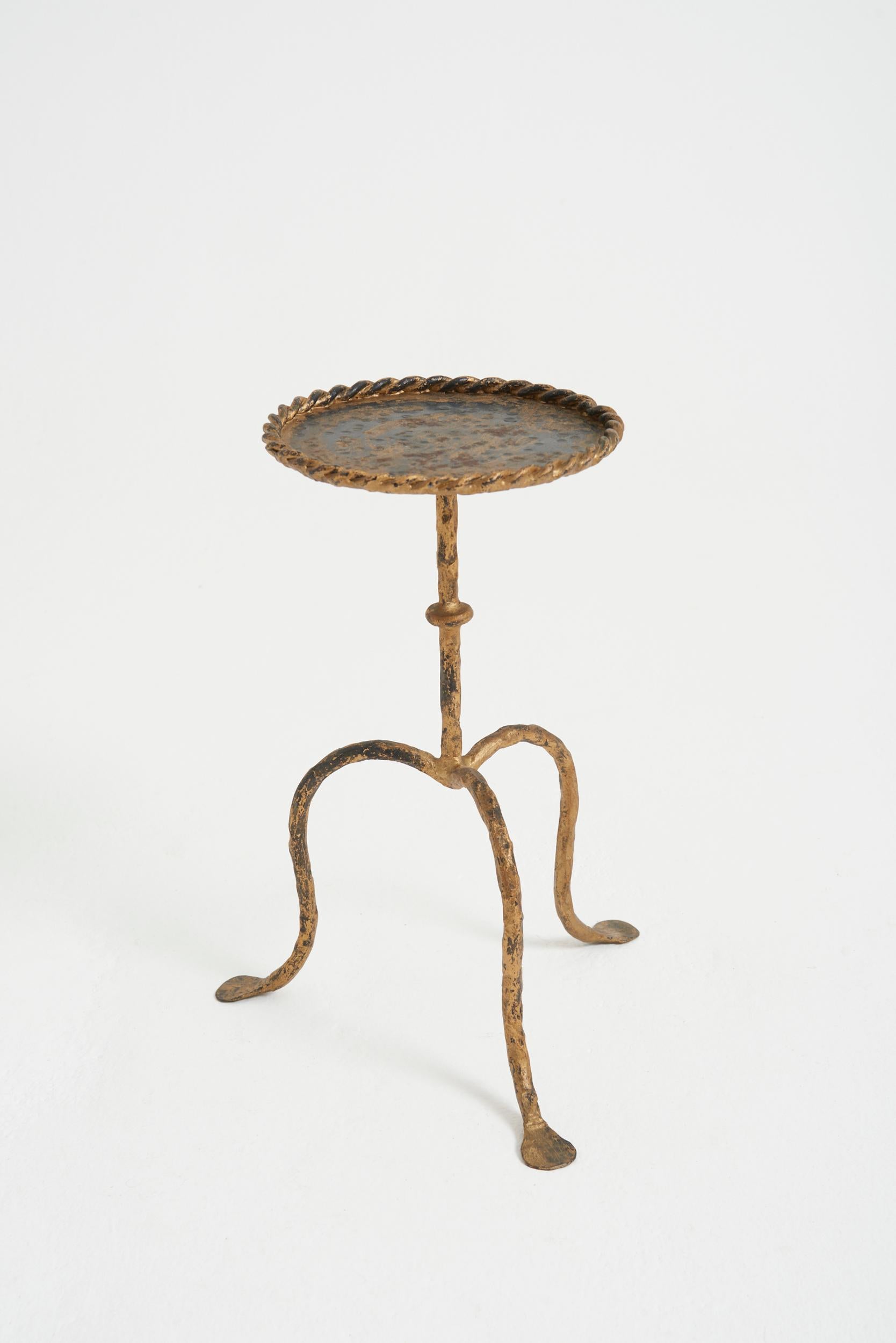 A gilt wrought iron martini table, of unusually reductive proportions
Spain third quarter of the 20th Century
40 cm high by 20.5 cm diameter