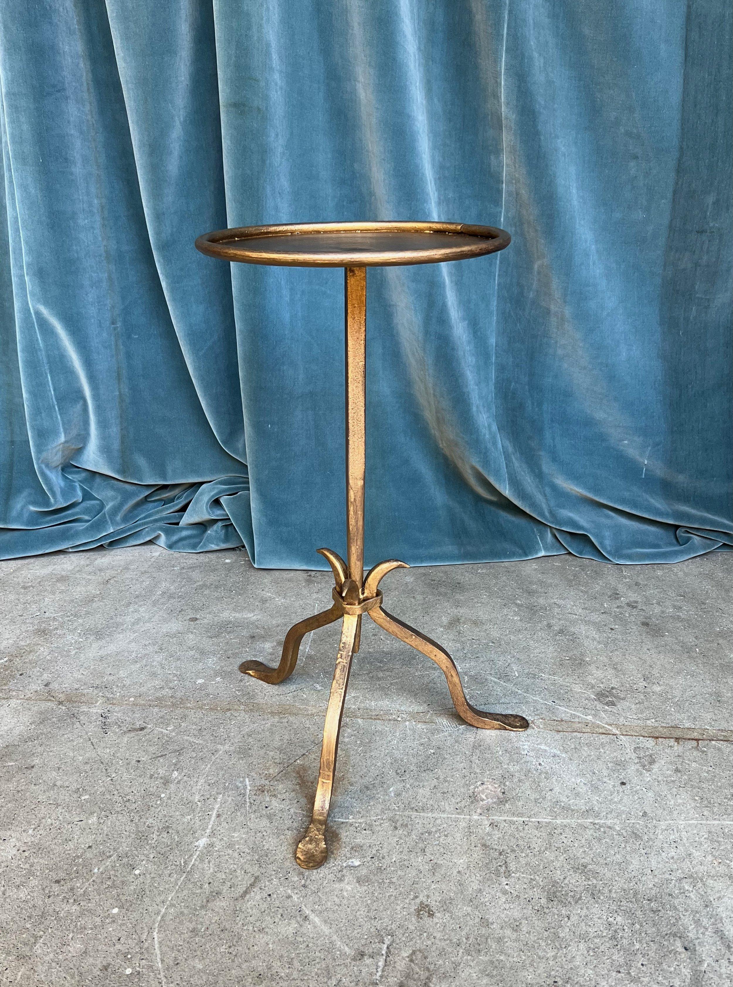 This lovely recently fabricated Spanish iron side table has a hand-applied gold patina that lends a sophisticated aura to any room. Created by accomplished artisans using traditional iron-working methods, the table features a distinctive design with