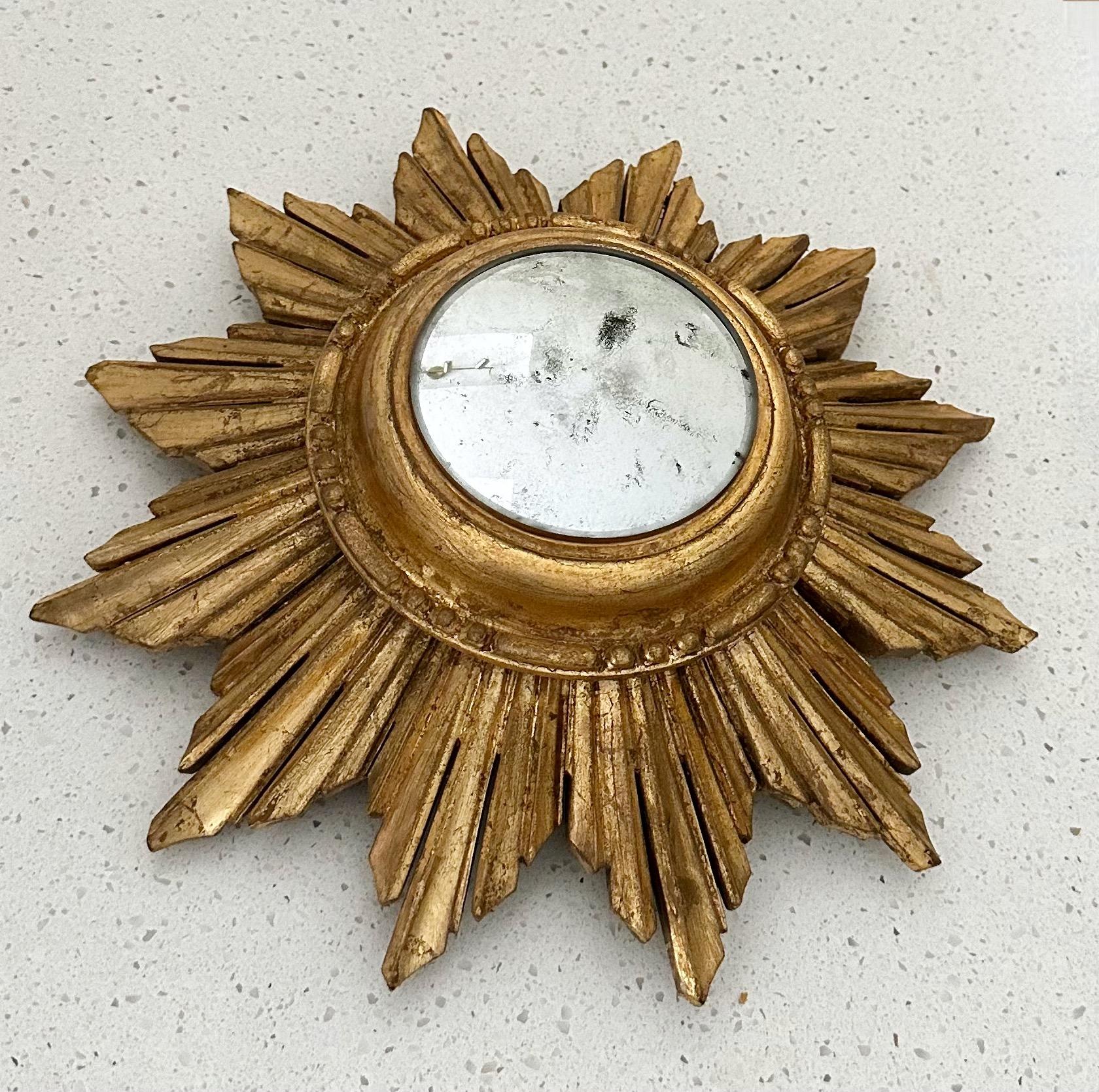 Smaller scale giltwood sunburst (starburst) convex wall mirror. Formally a clock convert to wall mirror with newer aged to look older convex mirror.  Overall size mirror 12