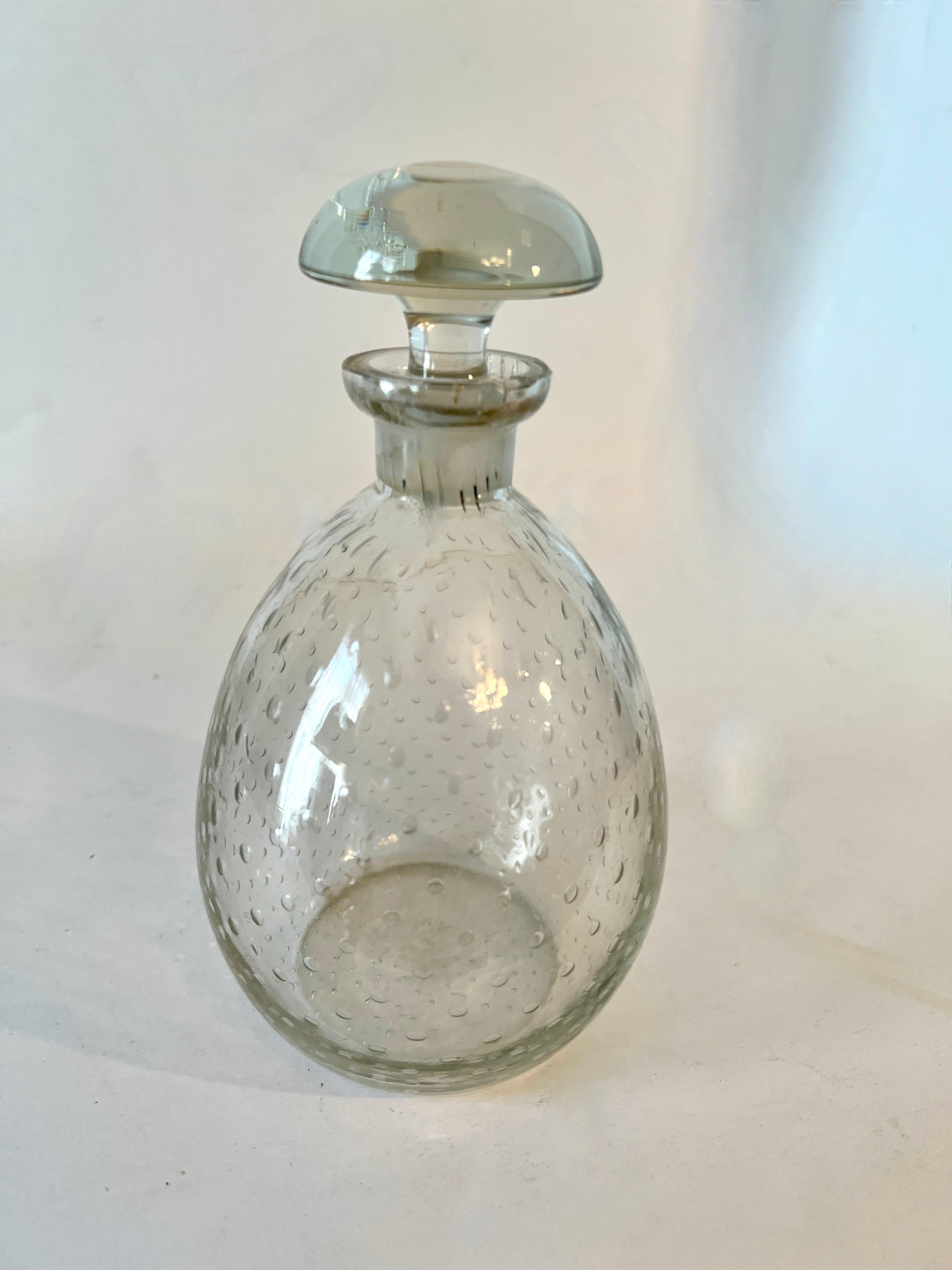 A small Decanter with stopper.  The piece is a nice addition to the bar for those small amounts of liquor or aperitif.

Additionally, we like this size decanter for the bathroom to hold mouthwash!  A very attractive way to display mouthwash on the