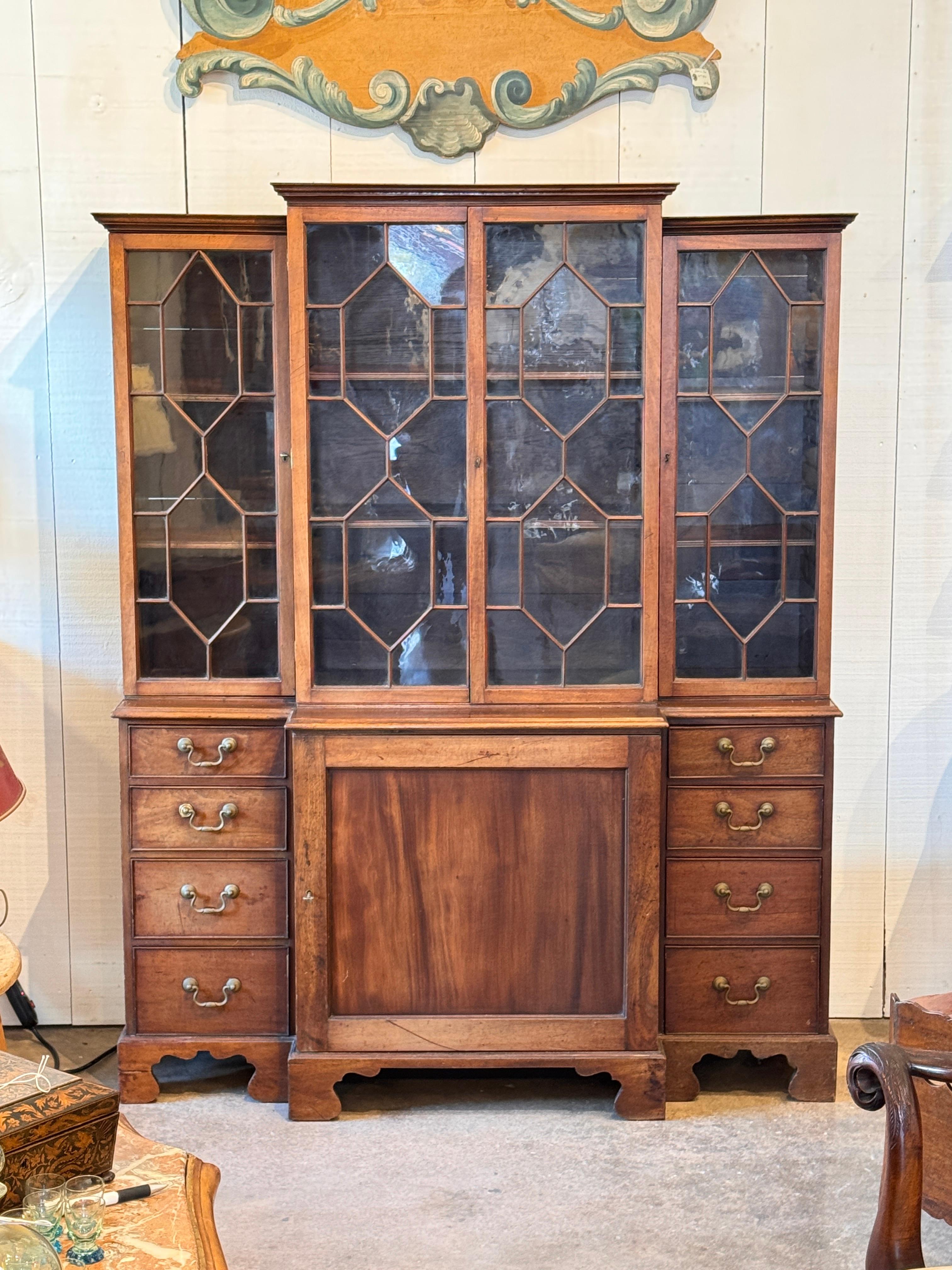 Small breakfront with glass-front upper doors featuring geometric mullions, above a central cupboard and flanking banks of drawers. The close-up images show tapered door edges that allow the glass doors to close cleanly, as well as simple drawer