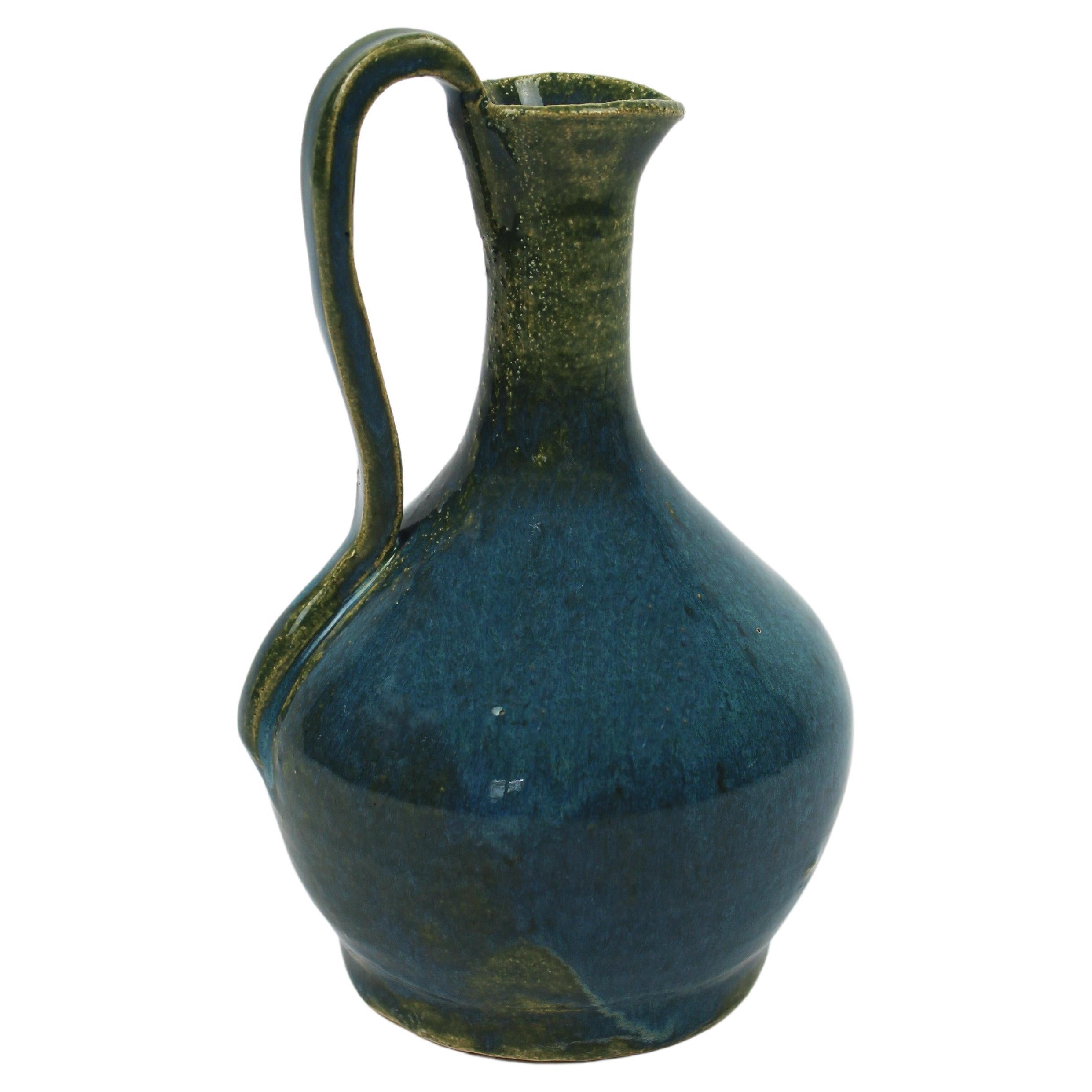 Small Glazed Ceramic Pitcher in hues of Turquoise and Green signed in the Bottom For Sale
