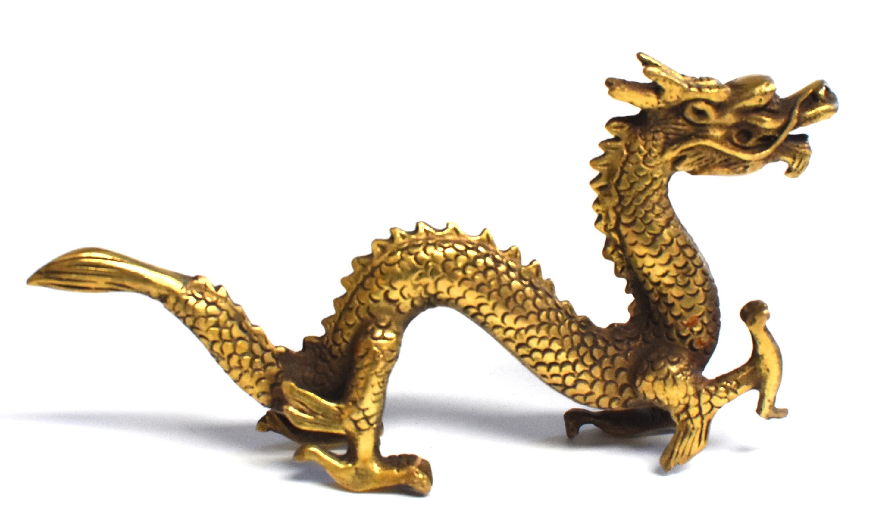 A beautiful small statue of dragon in the late Qing dynasty style. The four-clawed dragon has one front talon in pursuit of its subject, likely a flaming pearl, while the other three are firmly planted on the ground. The head strains forward with