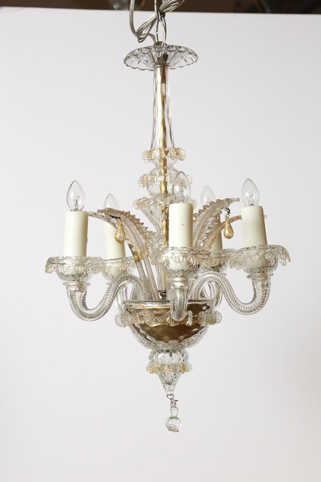 Small gold flecked Murano chandelier from Italy, circa 1930-1950. Clear hand blown glass chandelier decorated with gold flecks. Six arms accommodating candelabra-size sockets. Newly wired for use within the USA. Includes chain and a canopy. The