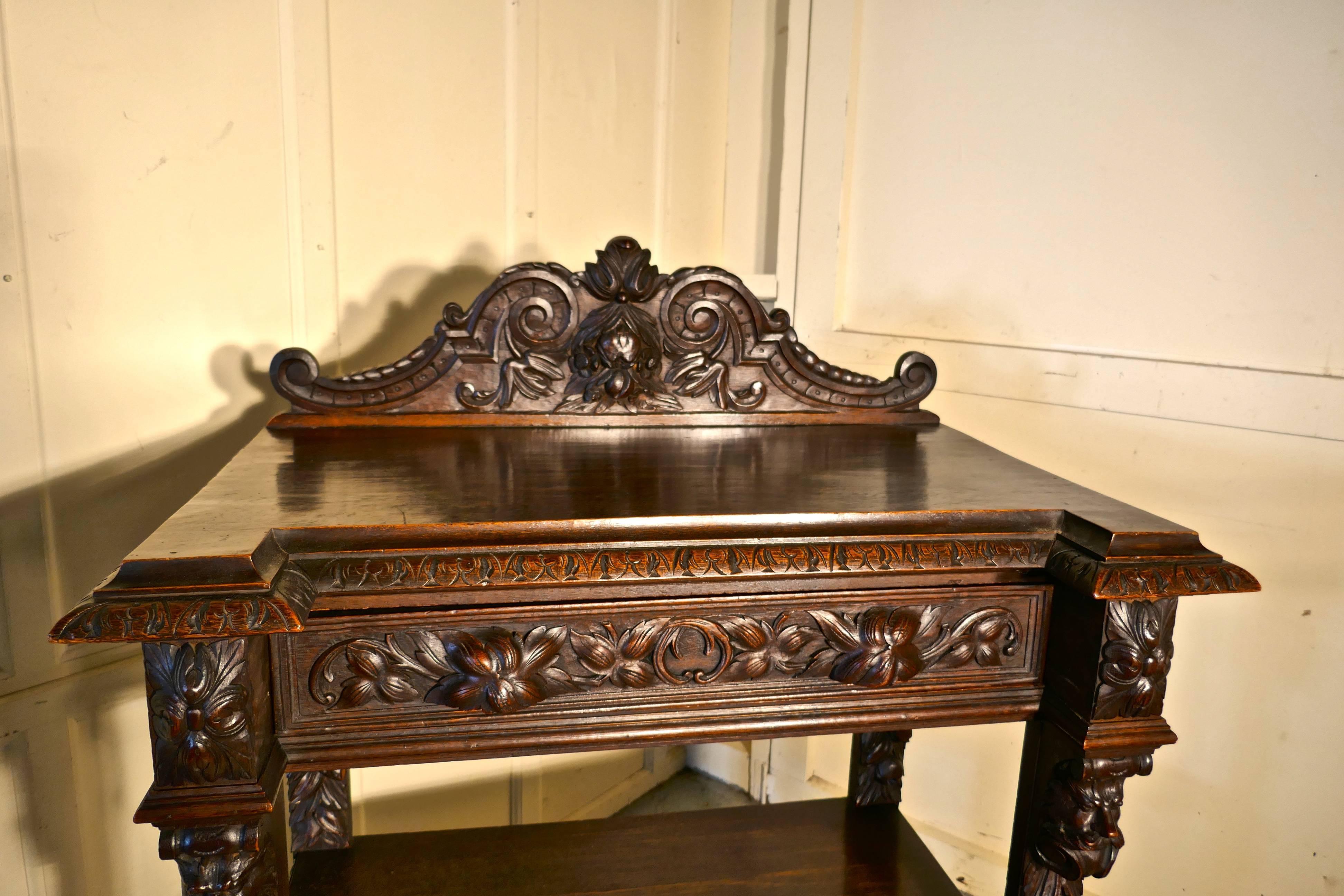 Small Gothic Victorian carved oak green man buffet. 

This is a very fine and superbly carved example of furniture carved in the Gothic style or Green Man oak.
The buffet has a three tiers with a carved gallery at the back, there is a drawer