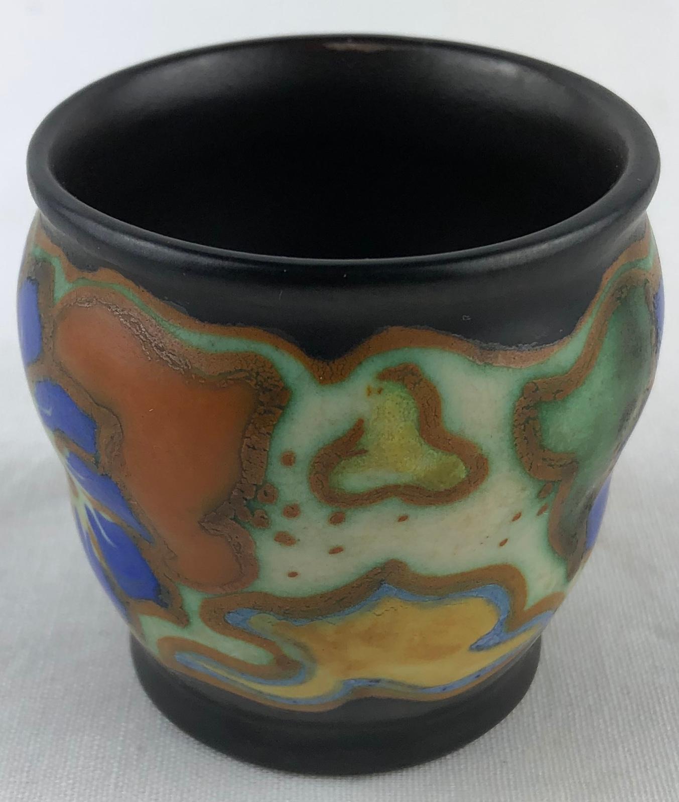 Dutch Art Deco ceramic cup or pen/pencil holder from Gouda, Holland with traditional period flowery and curvaceous designs, circa 1920s, matte glaze, which for us is the mixture of abstract and floral designs.

Very colorful and pleasing to the