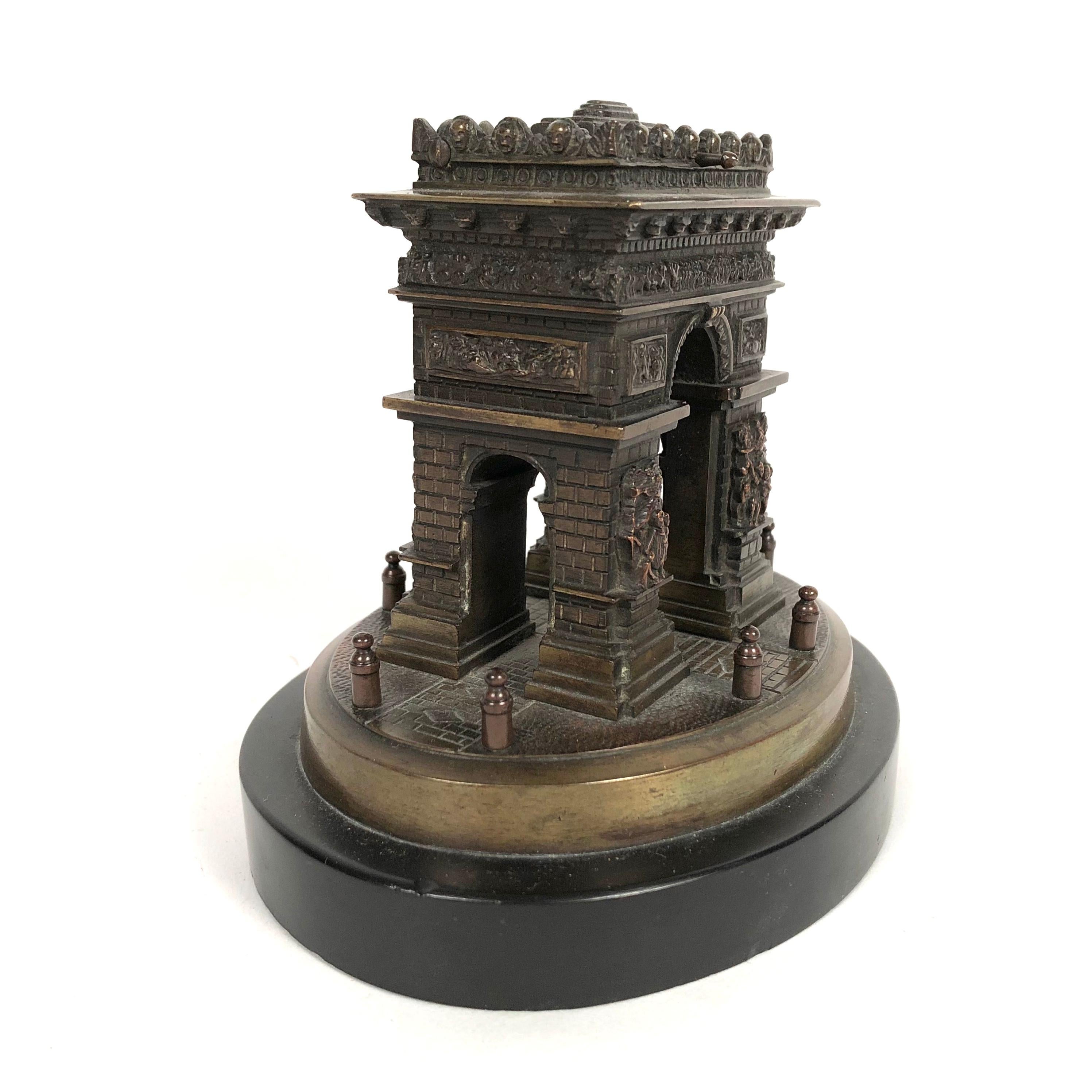 A small Grand Tour bronze architectural model of the Arc de Triomphe in Paris, mounted on black marble base. Created as a souvenir in the late 19th century for travelers to Paris, this model is very well detailed, showing the sculptural friezes on
