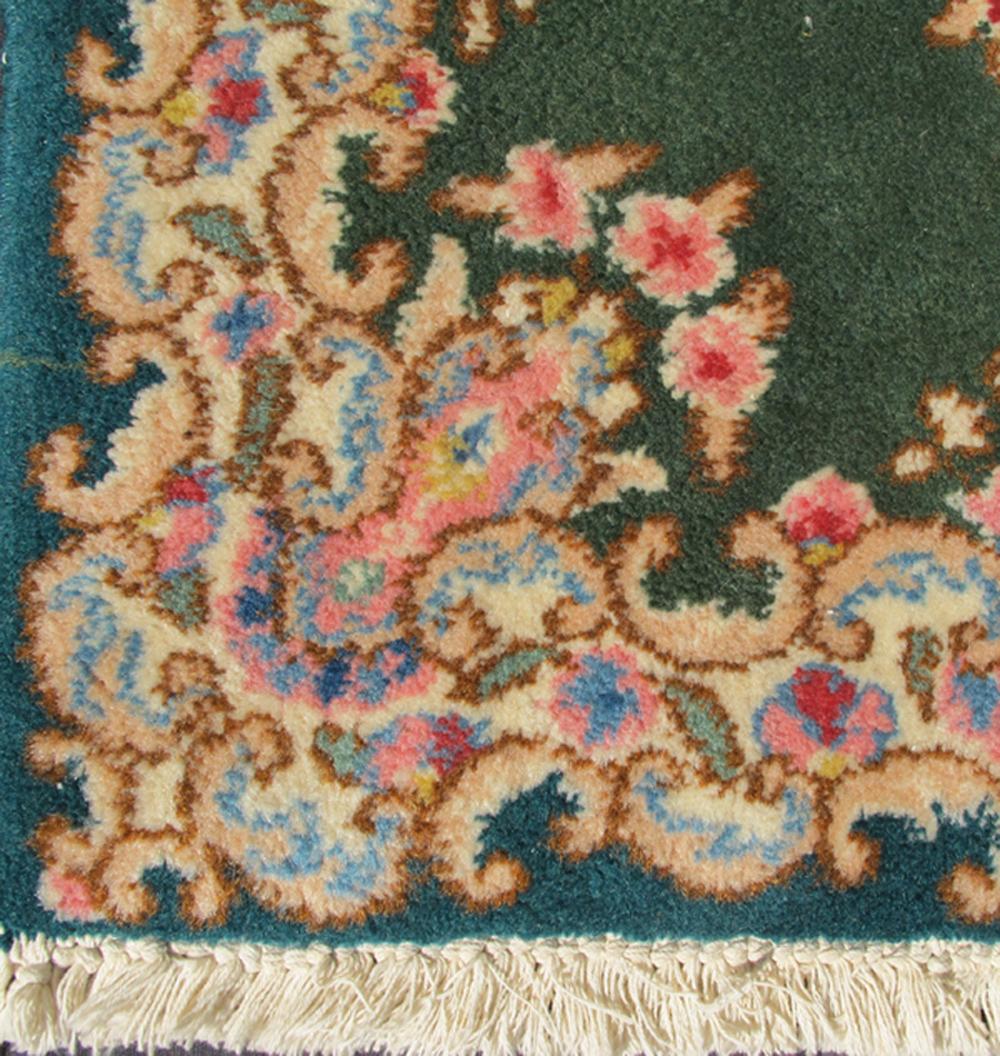 This mid-20th century Kerman carpet from Iran features a center medallion and matching floral border set atop a green background.
Measures: 2'0 x 3'0.