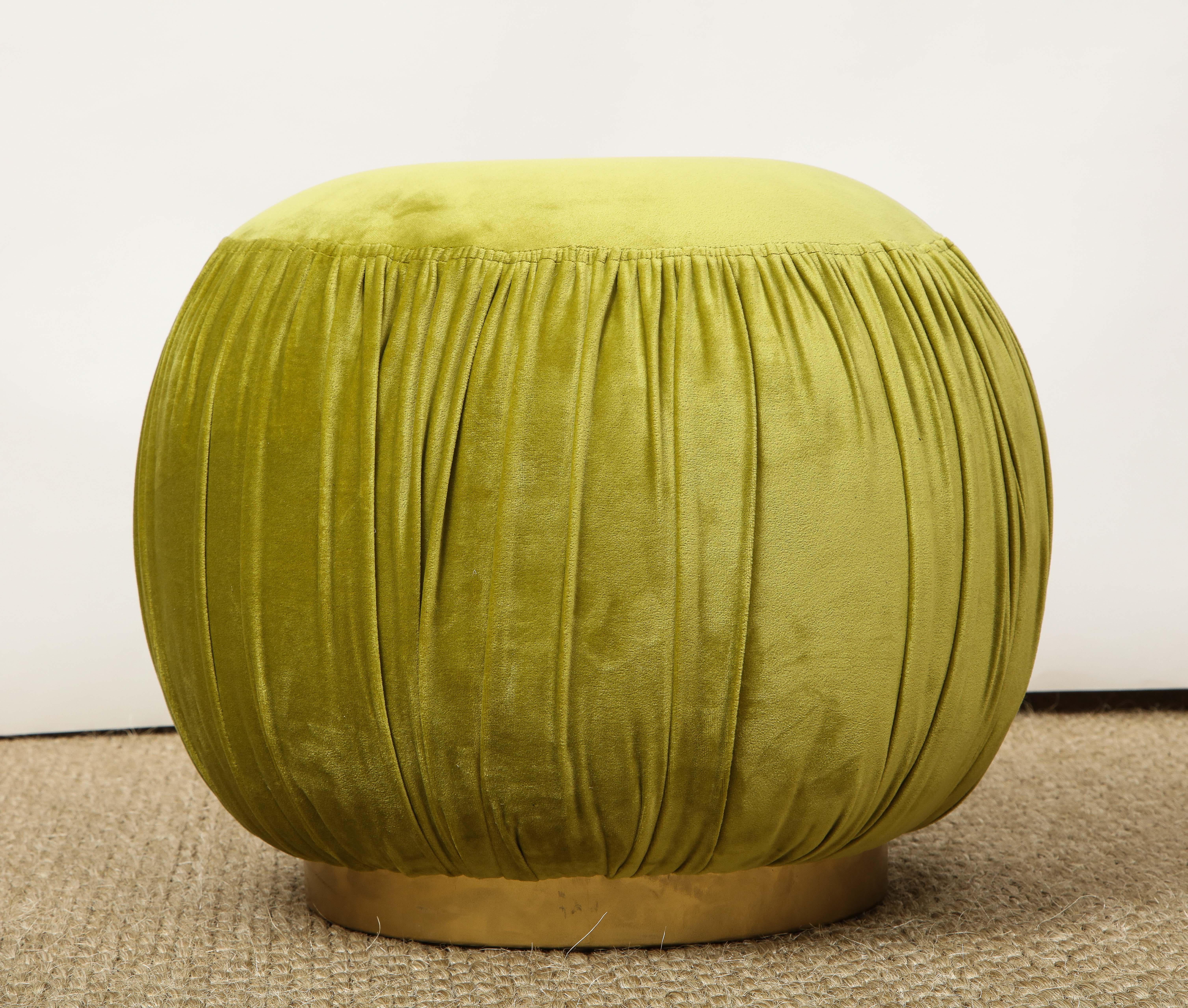 This adorable pouf could be just the right thing to add some punch and personality to a room! Upholstered in a chartreuse velvet, the pouf has a flat top, shirring around the circumference, and rests on a brass base. Perfect in a living room,