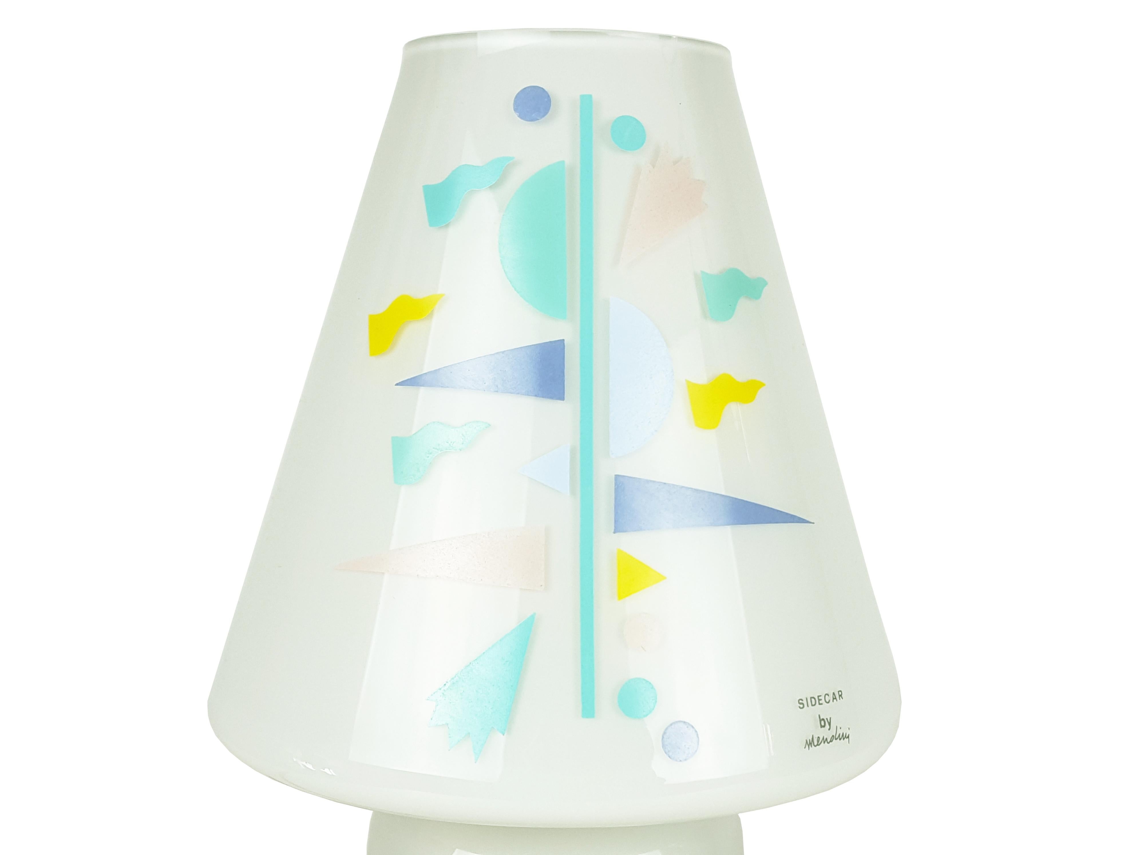 Light grey glass shade with multicolored geometrical decoration. The lamp remains in brand new condition with its original packaging.