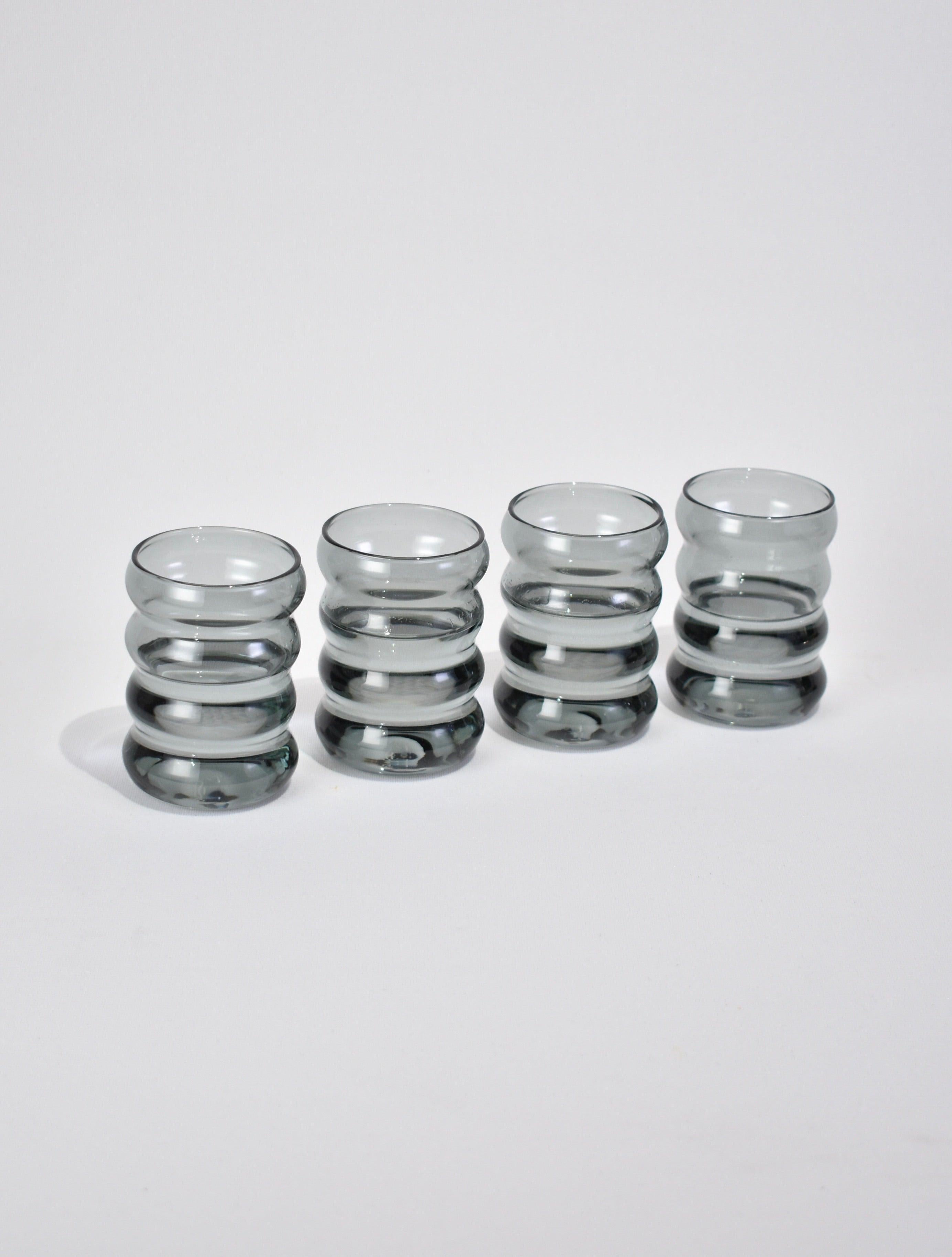 Wavy glass drinking cup set of four in grey. Perfect size for water, wine, juice or spirits. Designed by Sophie Lou Jacobsen in New York.

Made of lightweight and durable borosilicate glass. Cups are heat and cold resistant, and dishwasher safe.