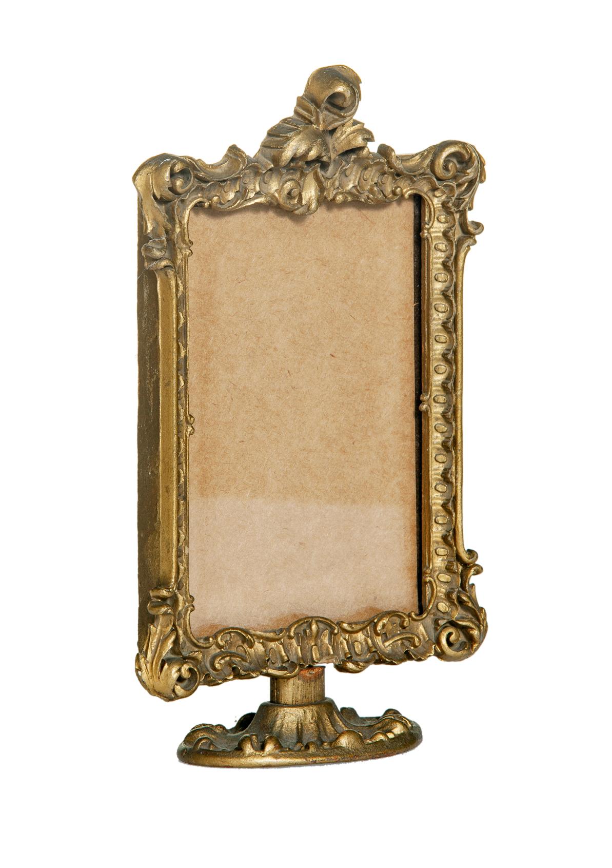 Pretty little French Victorian picture frame sits on an ornate round base. Lavish scrolls & meticulous details.
