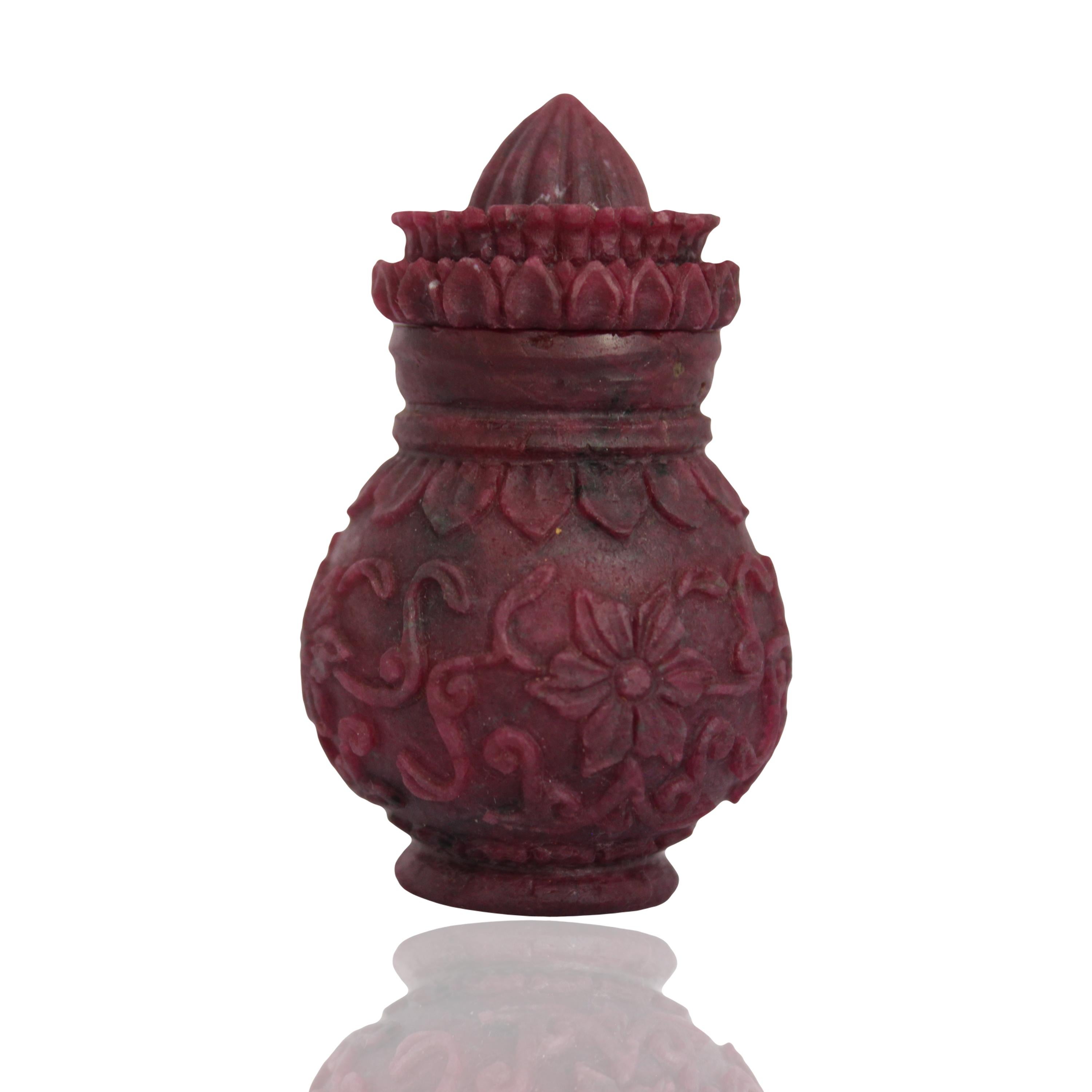 A natural ruby hand carved bottle hollowed from inside to keep vermilion, perfume or any other small precious holding. The bottle is shaped in form of traditional Indian design of Kalash used during various Indian celebration specially kept as on