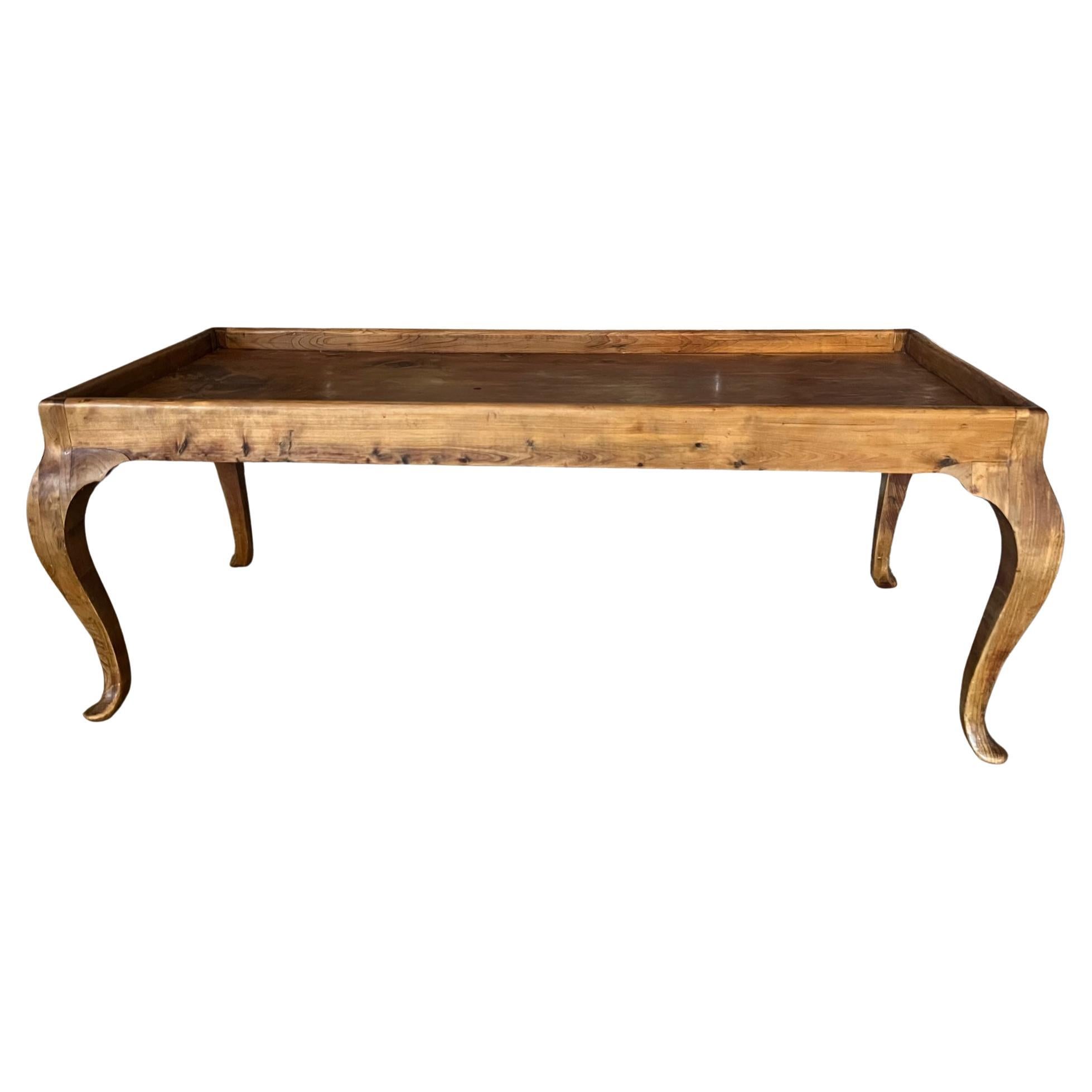 Light weight hand crafted coffee table made by a home furniture maker. The table with has cabriolet legs and rimmed top.

Table top measures 36.25 x 14.25