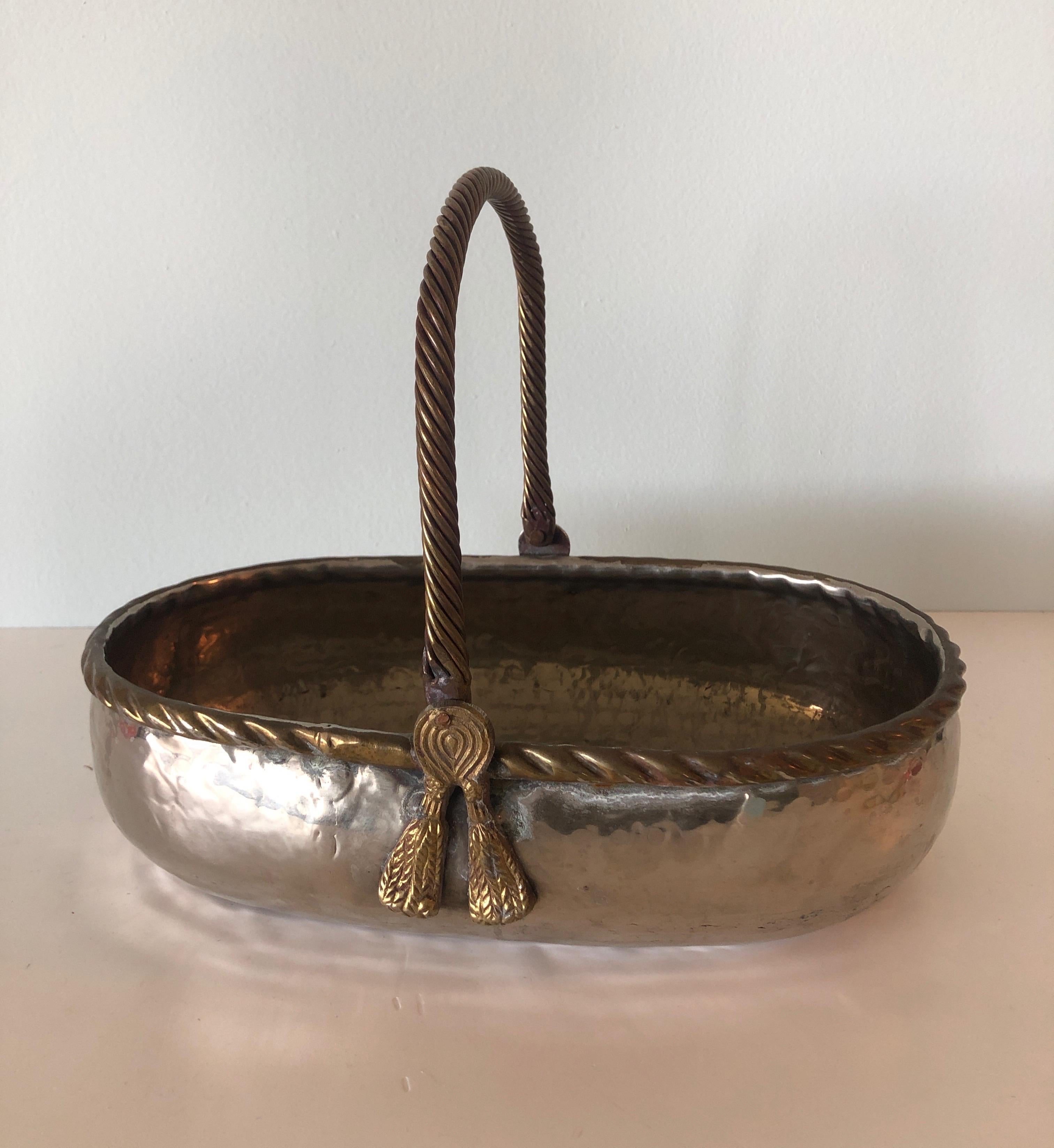 Small hand-hammered silver and brass Indian metal decorative basket.
Size: 11.75 x 6.75 x 3.75 