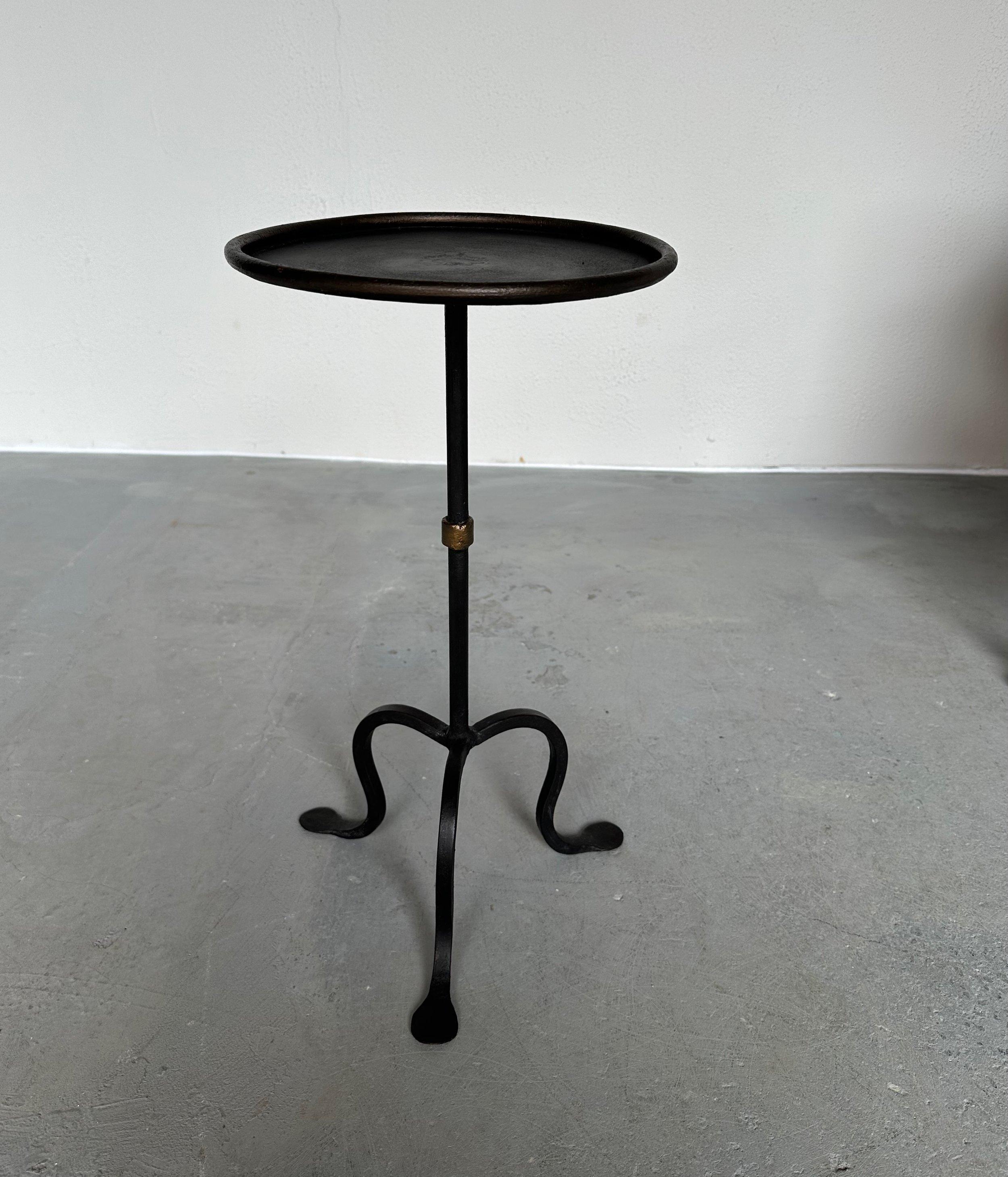 Based on one of our favorite vintage designs, this lovely Spanish iron drinks table was recently crafted to our specifications and features a hand-applied black finish with subtle gold accents around the circular rim and ring detail on the stem. It