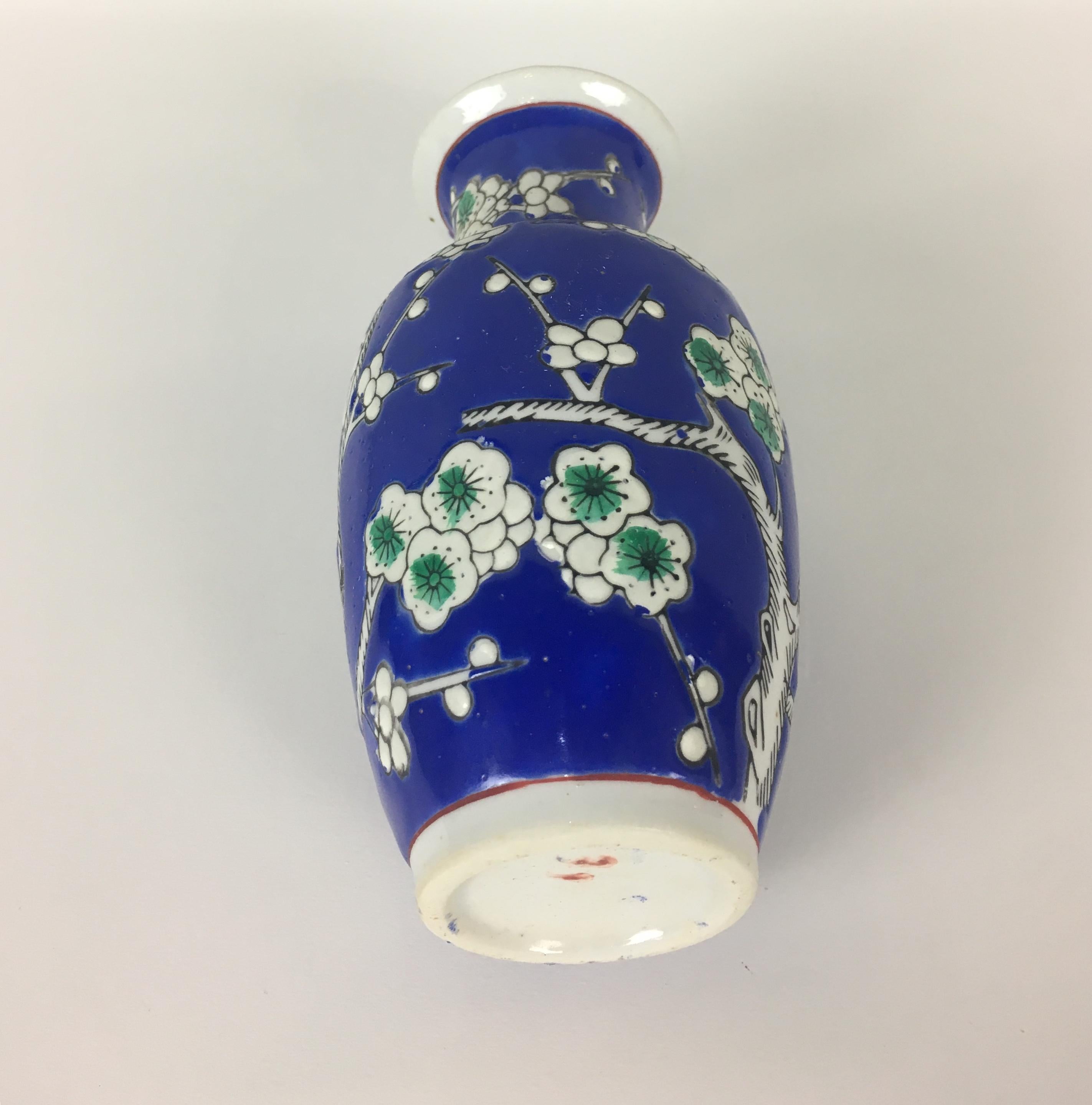 This small French chinoiserie vase with its vivid blue, white and green flowers is a delightful decorative object that would look great in a bathroom or on any shelf. Hand painted with attention to details.
Marked on the bottom.
No chips or cracks.