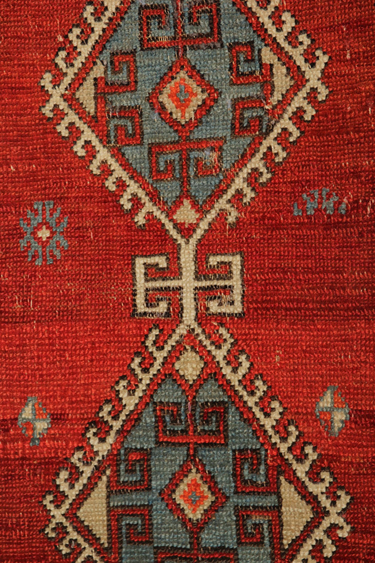 This simple little area rug is a fine example of a handwoven Turkish area rug. Woven with a blue and beige duo central medallion on a rich red background with repeat pattern border that frames the design. The colors and patterns used in this piece