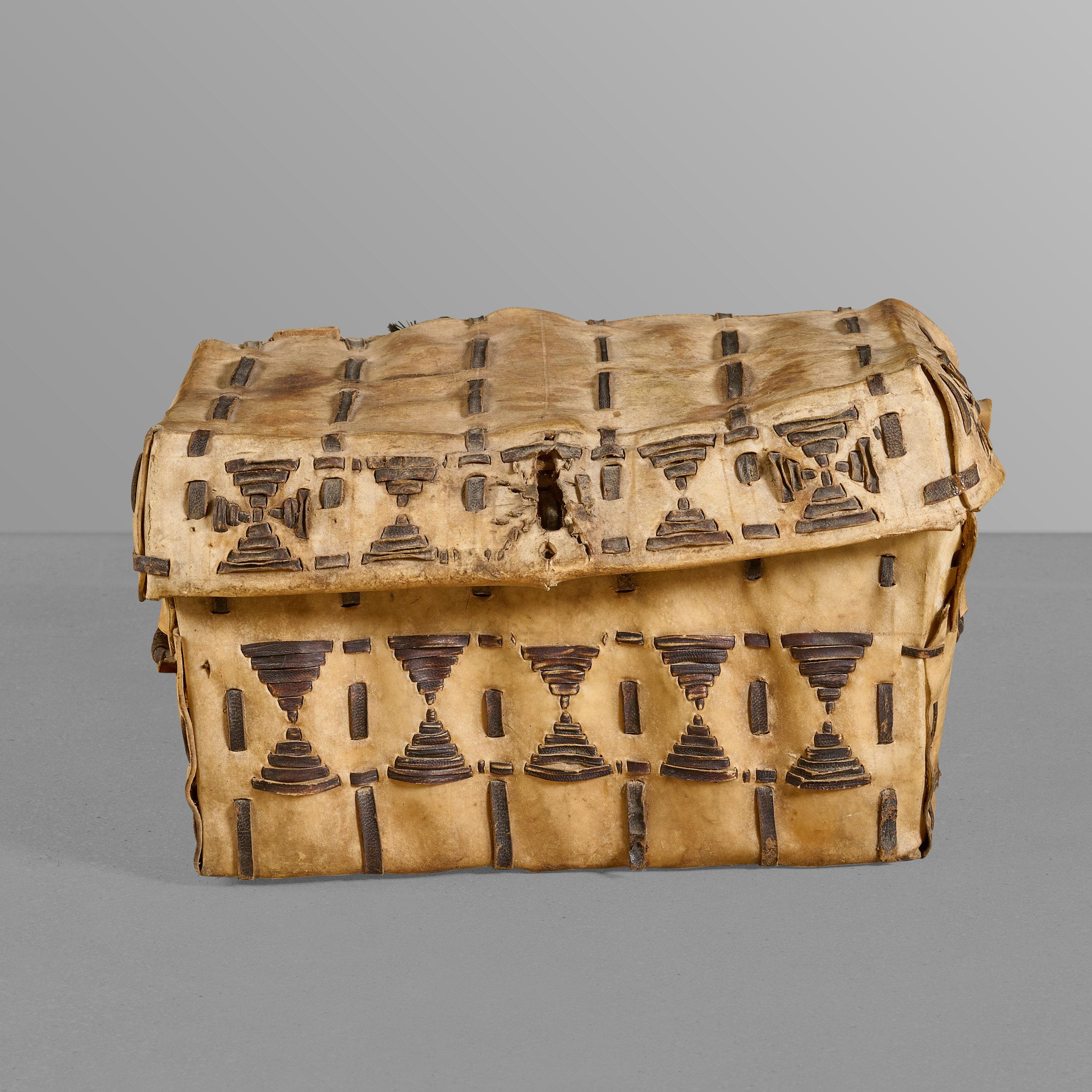 Small hide trunk with decorative stitching. Made by Gauchos for storage. Great style and quality.