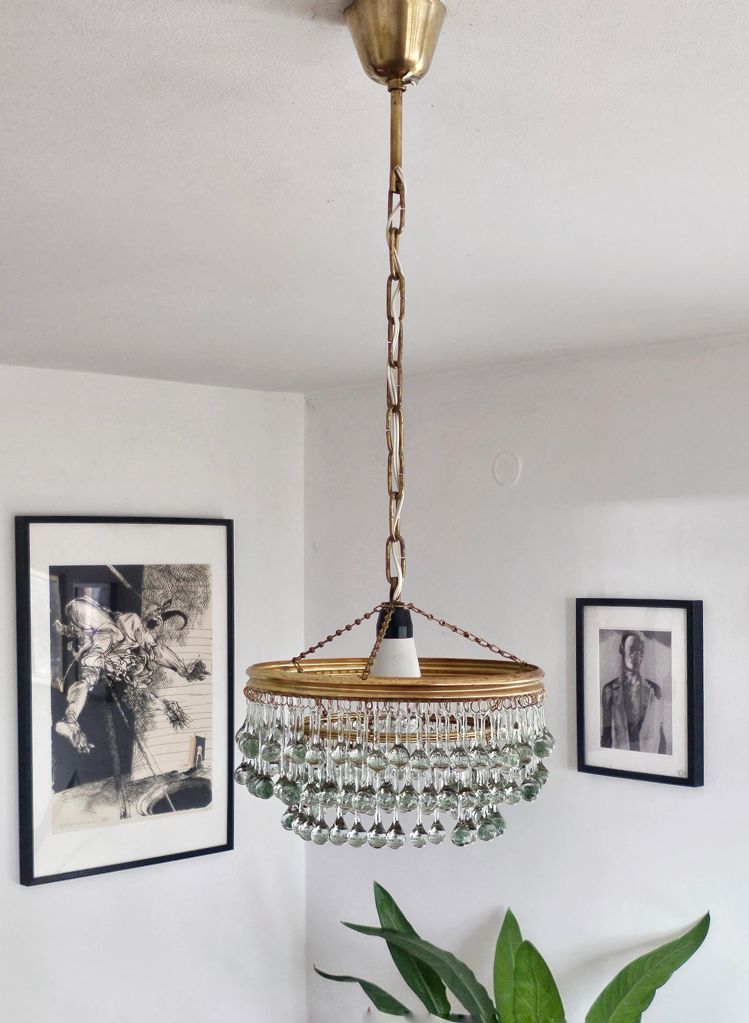 In this listing you will find a gorgeous, small Hollywood Regency chandelier with beautiful, small glass teardrops attached to brass fixture. This extremely elegant piece is perfect for small spaces - kitchen, entryway or bathroom. Made in Austria