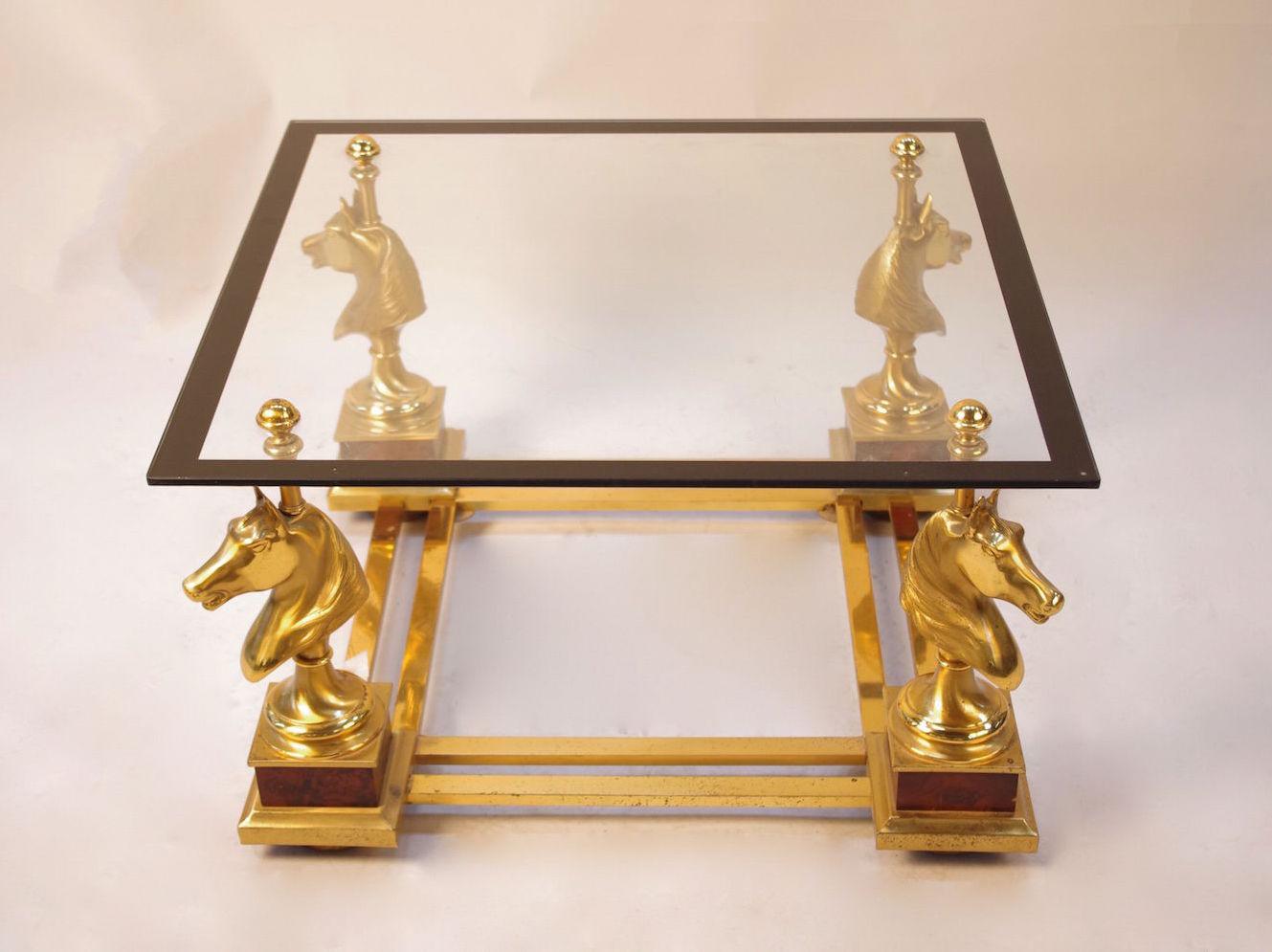 Maison Charles, in the style of.

Horse coffee table in gilt bronze and glass standing on four legs in horse head shape standing on thuya burl painted cubes and finishing by wood bun foot. Legs are linked each other by a stretcher made with double