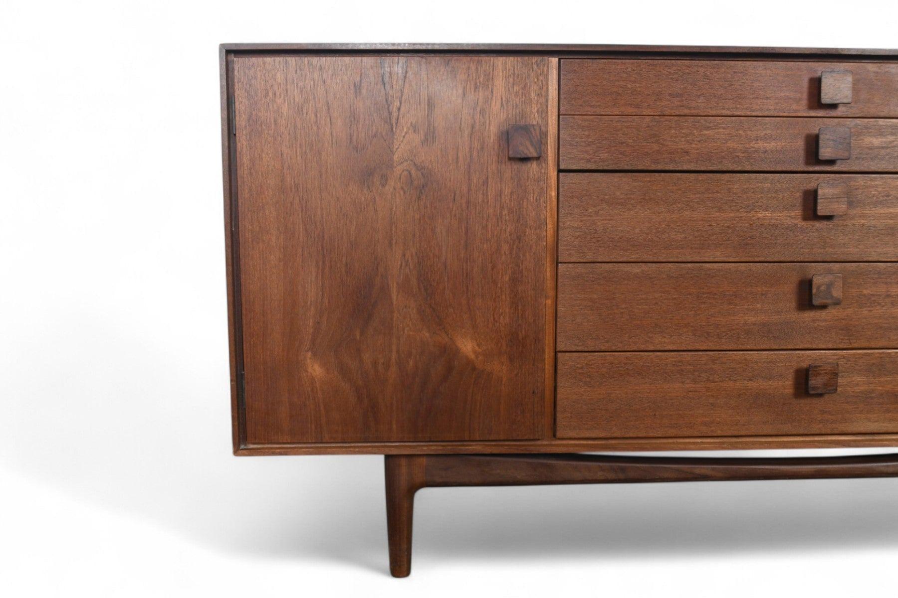 Origin: England
Designer: Ib Kofod Larsen
Manufacturer: G Plan
Era: 1961
Materials: Teak, Rosewood, Afromosia
Measurements: 66″ wide x 19.5″ deep x 30″ tall