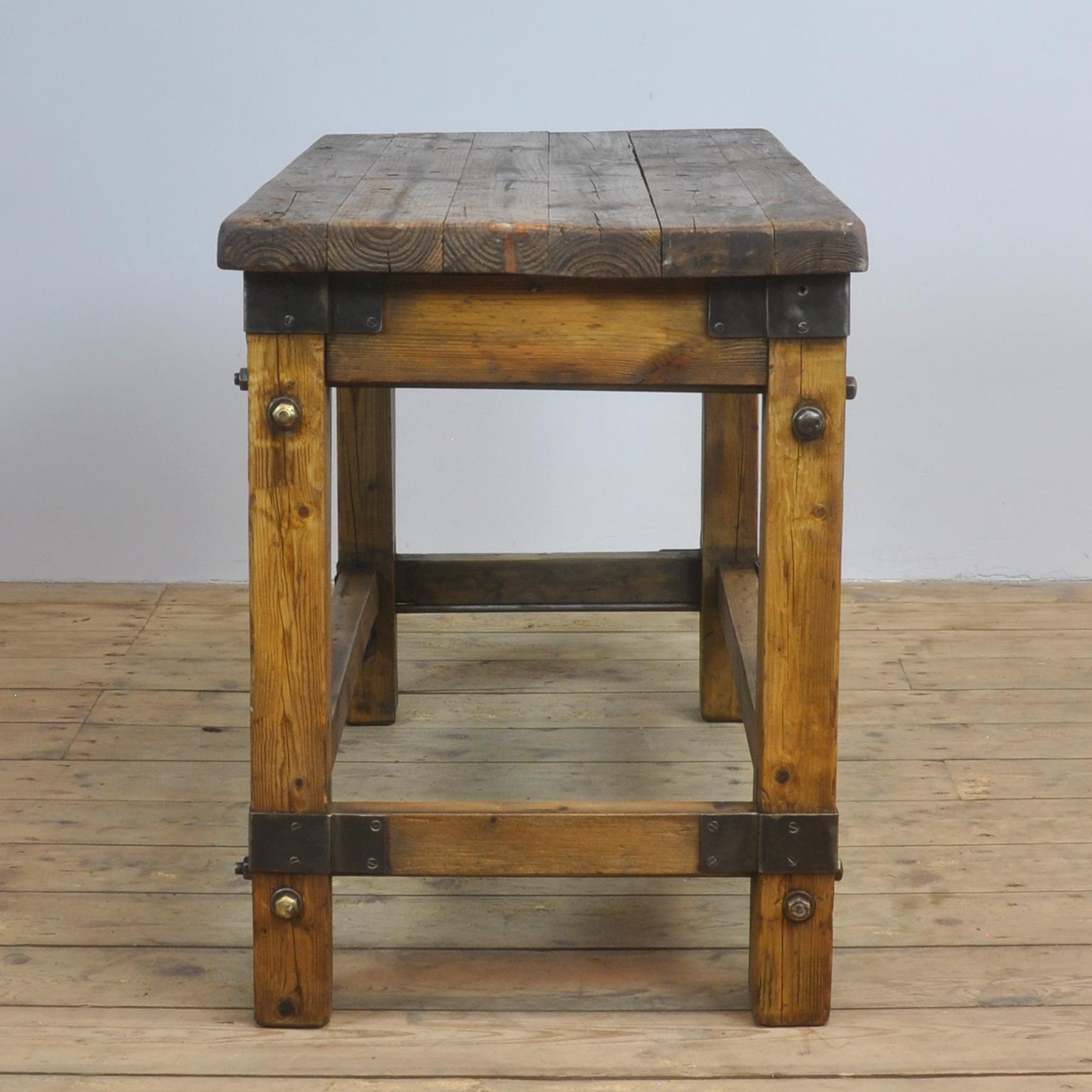Small industrial table made of pine with iron details, circa 1950.