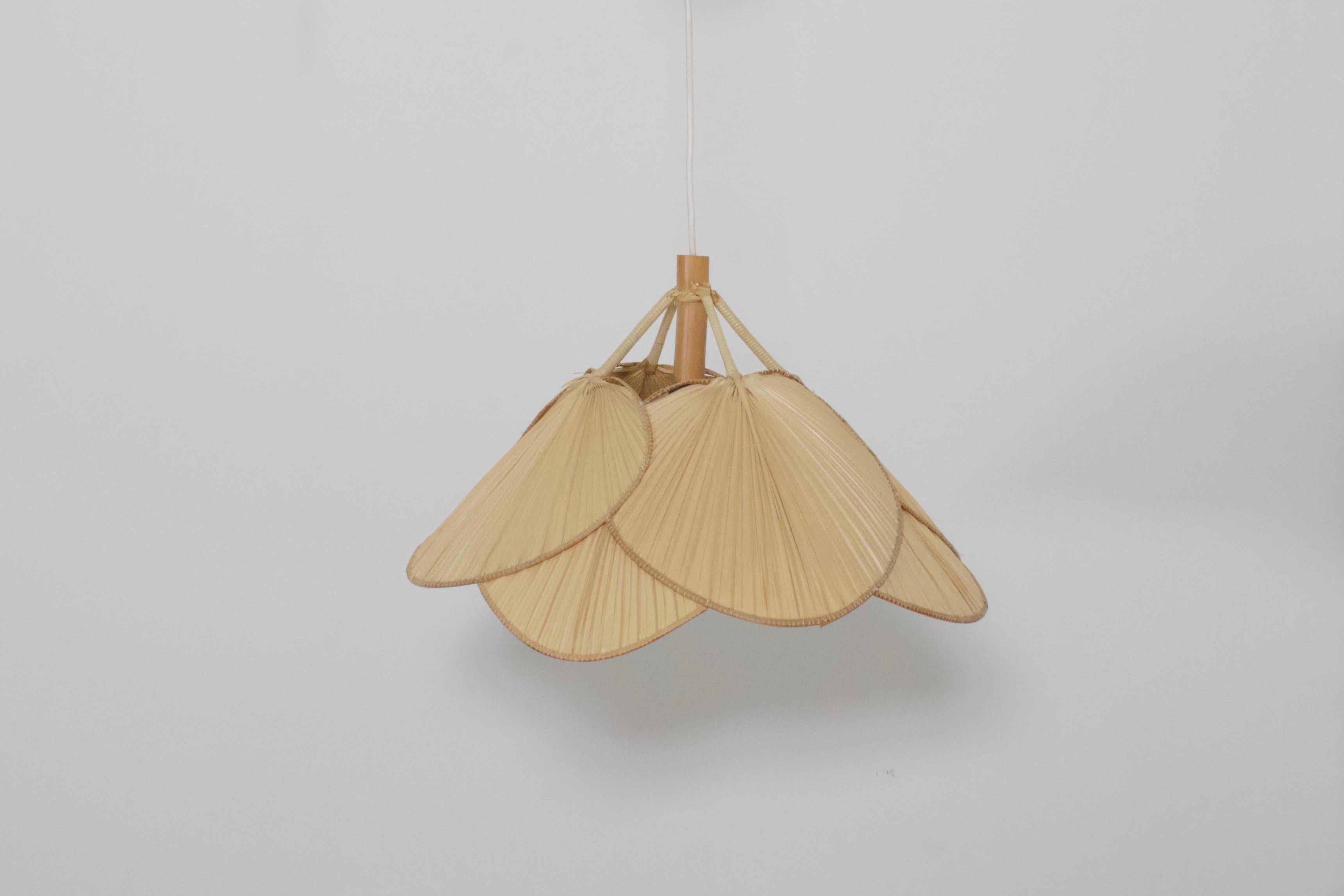 Small ‘Uchiwa’ chandelier by Ingo Maurer in very good condition. 

Designed by Ingo Maurer. 

This lamp is handmade from bamboo and Japanese rice paper. 

The lamp consists 8 fans hanging from a bamboo frame. 

When lit the lamp gives a