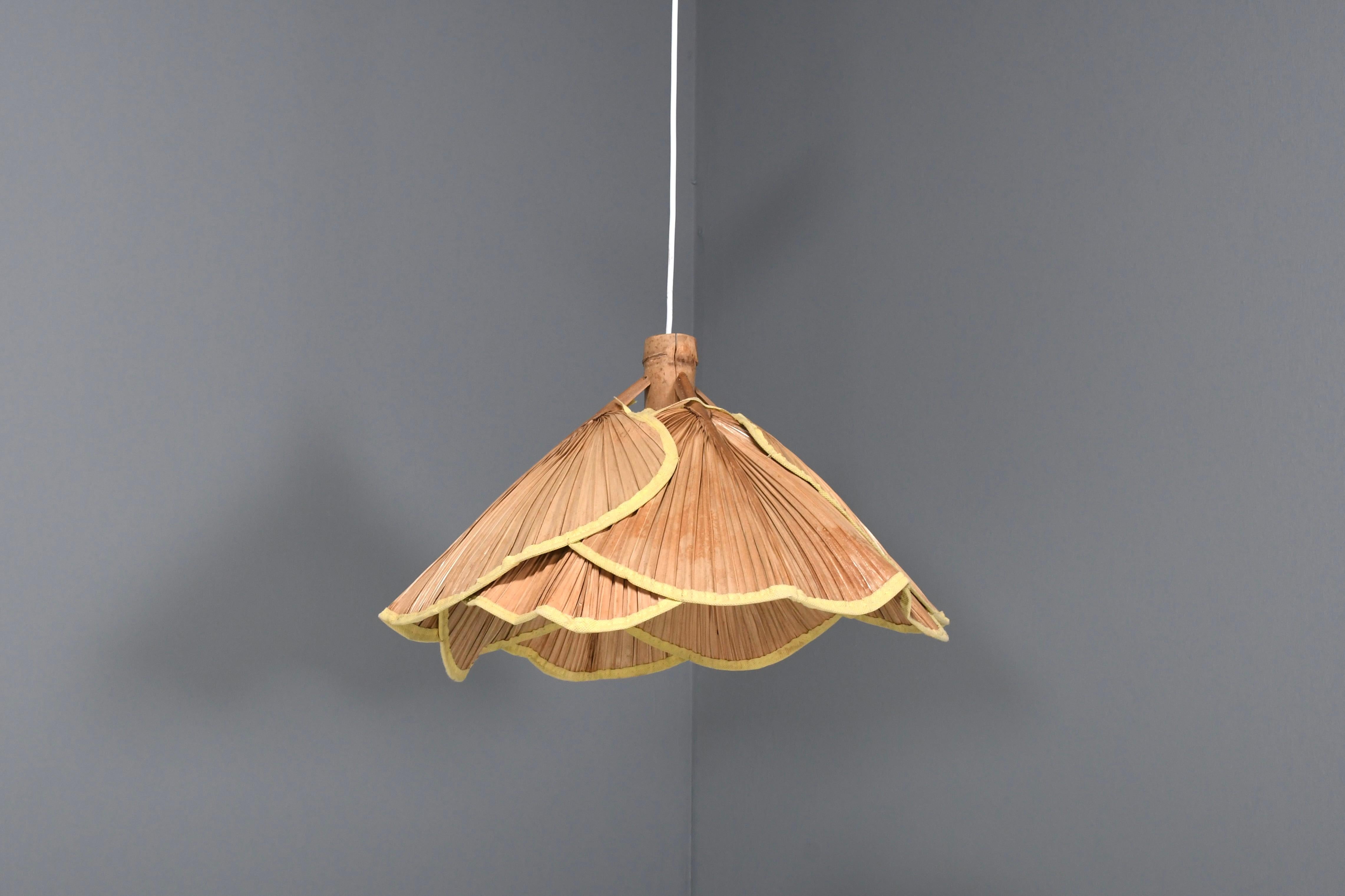 Small ‘Uchiwa’ chandelier in the style of Ingo Maurer in good condition. 

This lamp is handmade from bamboo and Japanese rice paper. 

The lamp consists 8 fans hanging from a bamboo frame. 

When lit the lamp gives a beautiful warm light. 

The