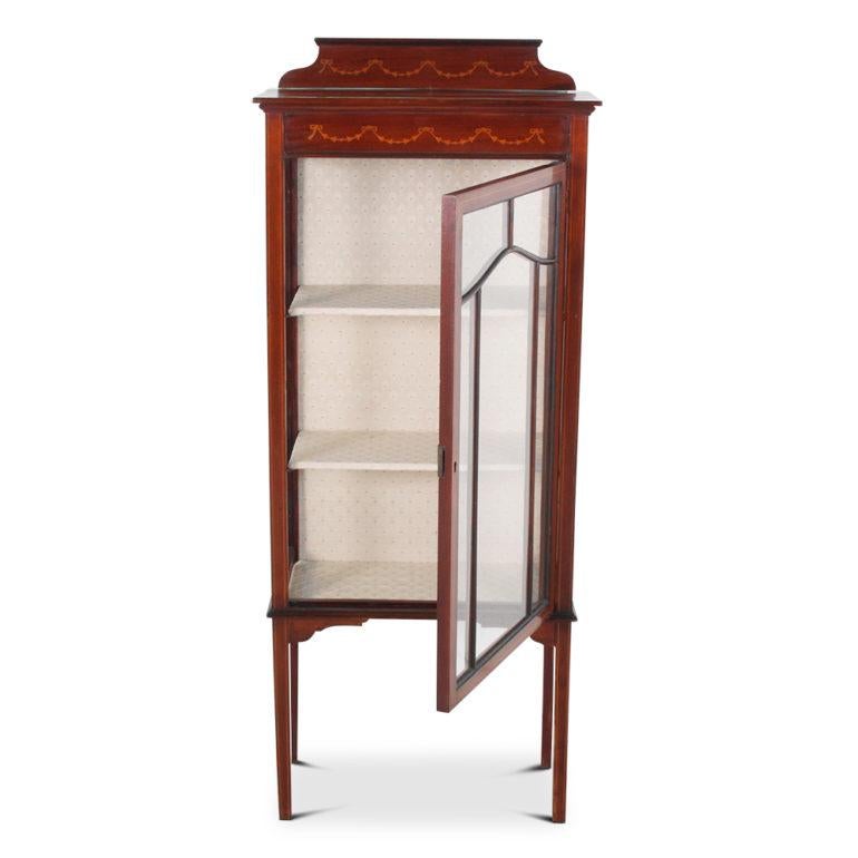 An unusually small, English Edwardian single-door display cabinet, with two shelves and raised on square tapering legs, circa 1910.



   